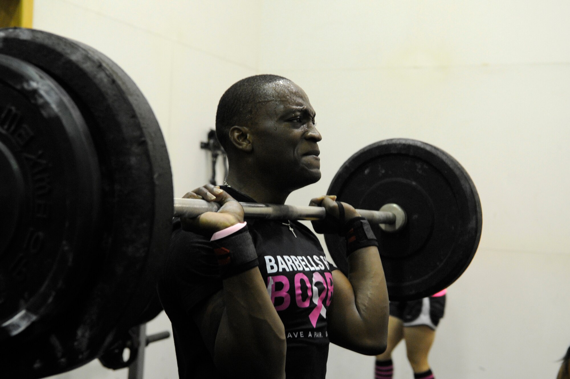 Tech. Sgt. Kunle Thomas, 35th Fighter Squadron, completes a clean and jerk during a CrossFit workout dedicated to breast cancer awareness Oct. 20, 2012, at Kunsan Air Base. In 2011, an estimated 39,520 women out of 230,480 diagnosed with invasive breast cancer died. (U.S. Air Force photo/Senior Airman Brigitte N. Brantley)