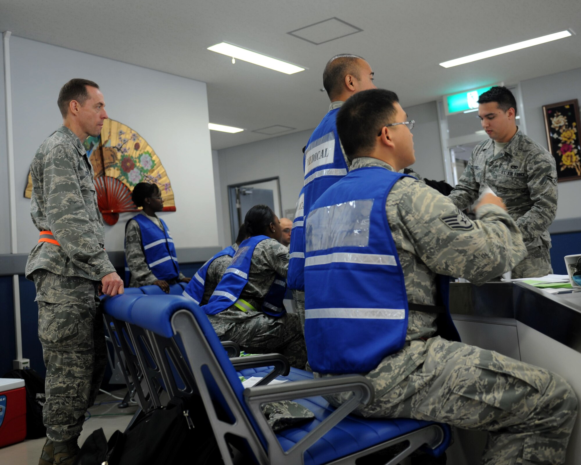 U.S. Air Force Col. John Lynch, 18th Aerospace Medicine Squadron commander, supervises 18th AMDS medical personnel processing Airmen at a deployment processing line during a Pacific Air Forces readiness inspection on Kadena Air Base, Japan, Oct. 23, 2012. The readiness inspection, which began earlier this week, tested the 18th Wing on its ability to survive and operate during a contingency operation. (U.S. Air Force photo/Airman 1st Class Hailey R. Davis)