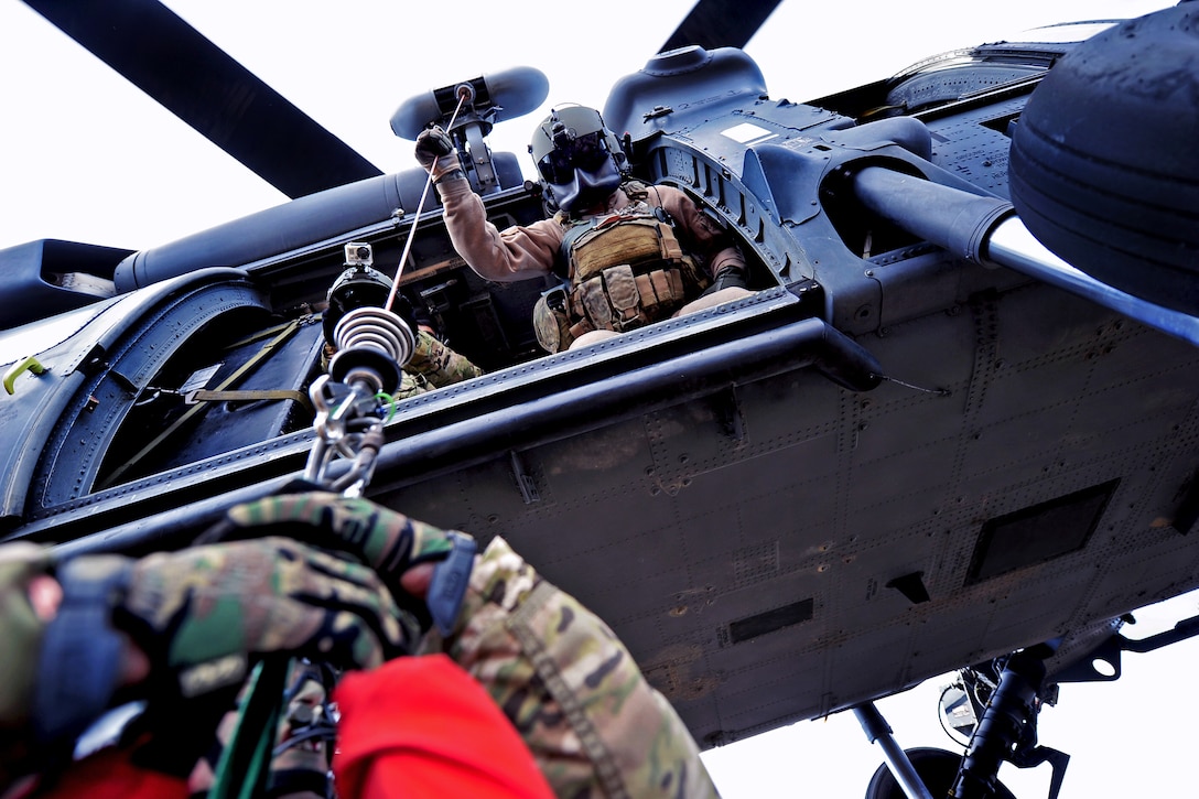 U.S. Air Force Staff Sgt. Brandon Taylor hoists simulated survivors into a HH-60 Pave Hawk helicopter as part of a combat search and rescue scenario during exercise Pacific Thunder 2012 near Osan Air Base, South Korea, Oct. 15, 2012. Taylor, a flight engineer, is assigned to the 33rd Rescue Squadron. 
