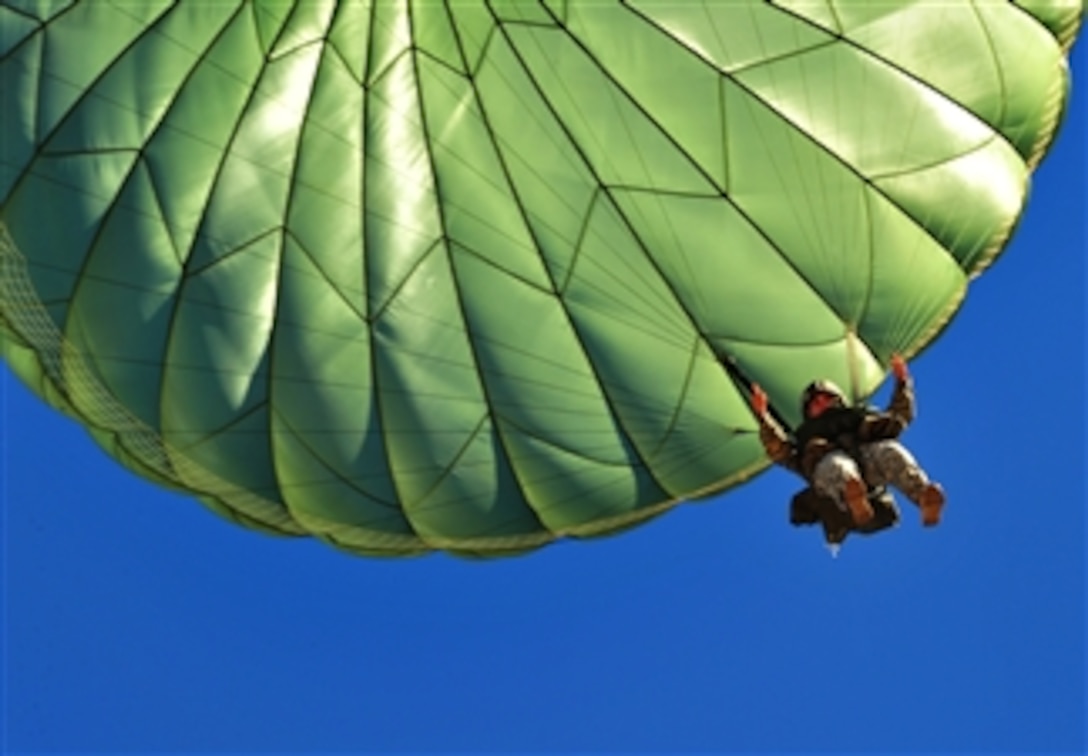 A U.S. Army paratrooper gives the thumbs up before landing on the drop zone at Fort Bragg, N.C., on Oct. 11, 2012.   The personnel airdrop is part of a U.S. Army and Air Force joint operational access exercise designed to properly execute large-scale heavy equipment and troop movement.  