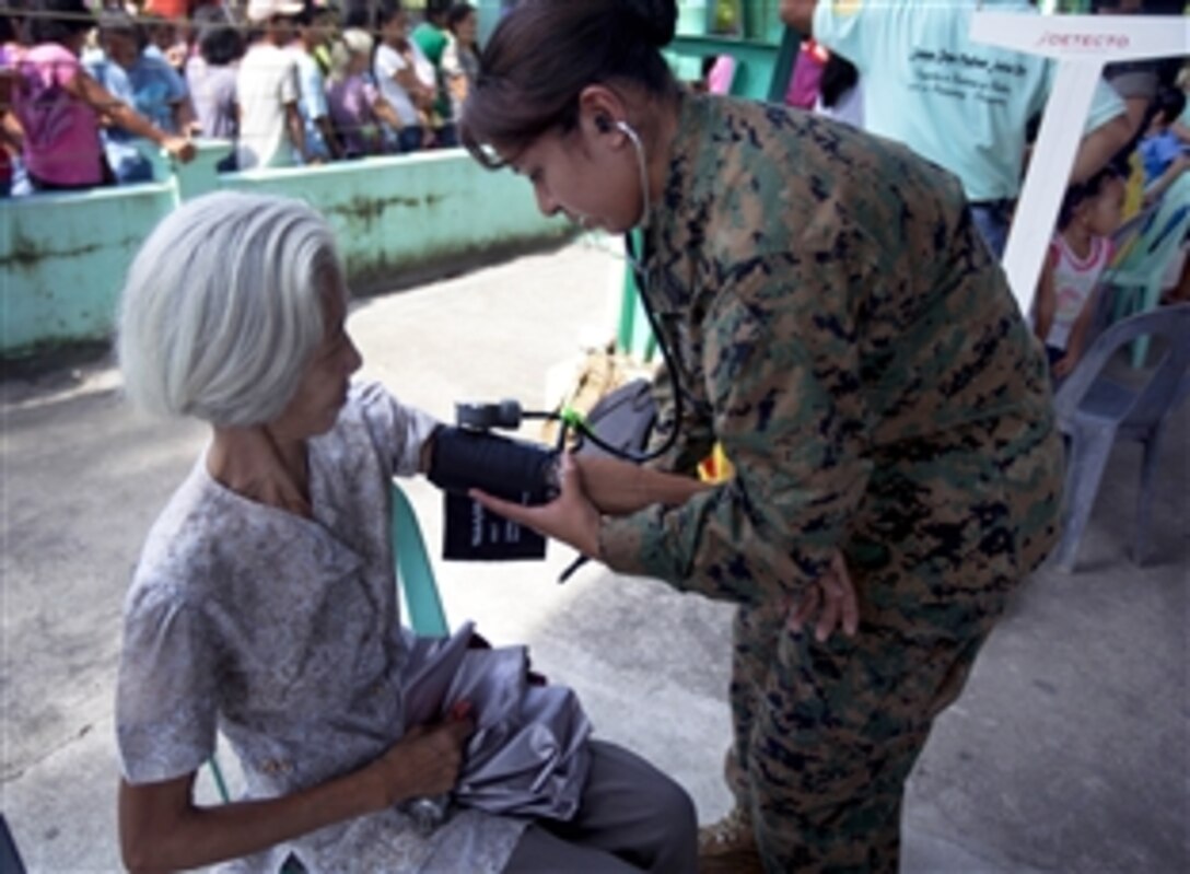 U.S. Navy Petty Officer 2nd Class Patricia Lopez-Cruz, right, performs a basic checkup on Patricio Magdalen at a Dental and Medical Civic Action Program during Amphibious Landing Exercise, PHIBLEX 2013, in Barangay Burgos, San Antonio, Zambales, Philippines, Oct. 12, 2012. Lopez-Cruz, a hospital corpman, is assigned to the 3rd Marine Expeditionary Brigade, III Marine Expeditionary Force. 