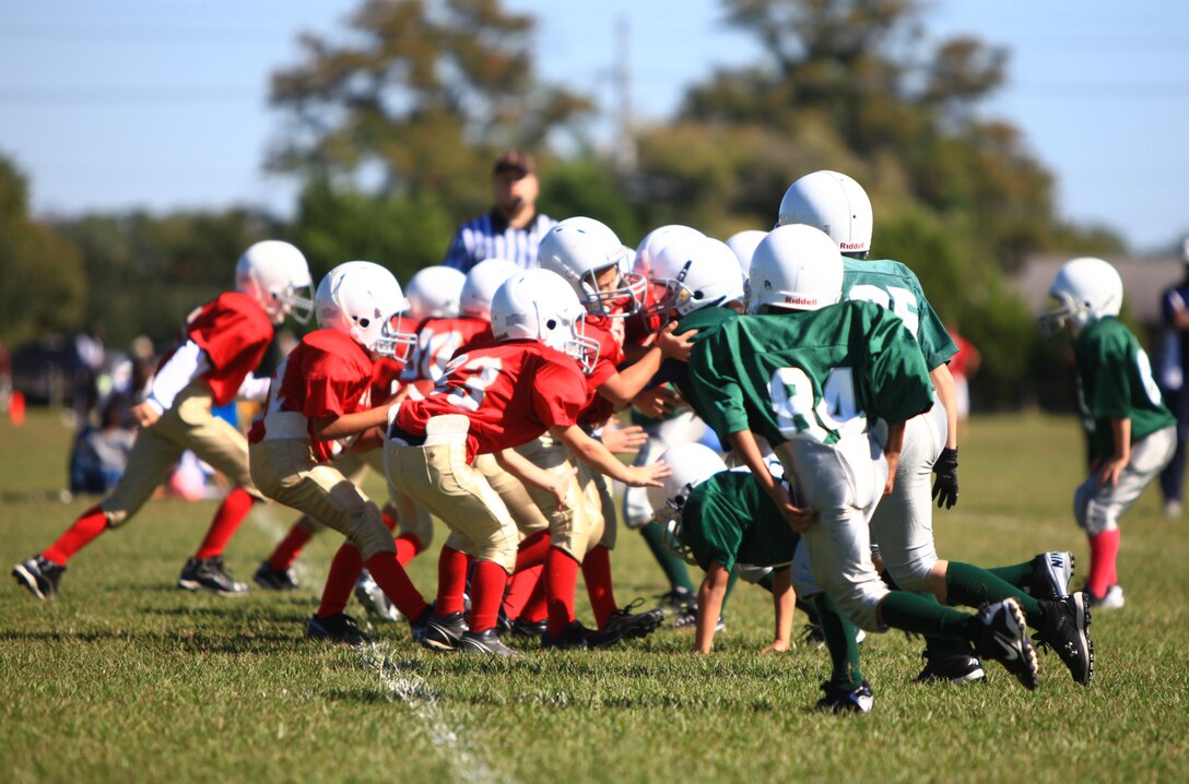 The Eagles and 49ers clash during a youth football game aboard Camp Lejeune, N.C., Oct. 20, 2012. Gunnery Sgt. Jesus M. Melendrez, the operations chief for Combat Logistics Regiment 25, 2nd Marine Logistics Group, coached the Eagles to victory in the game as part of his daily routine of mentoring young athletes on base. 