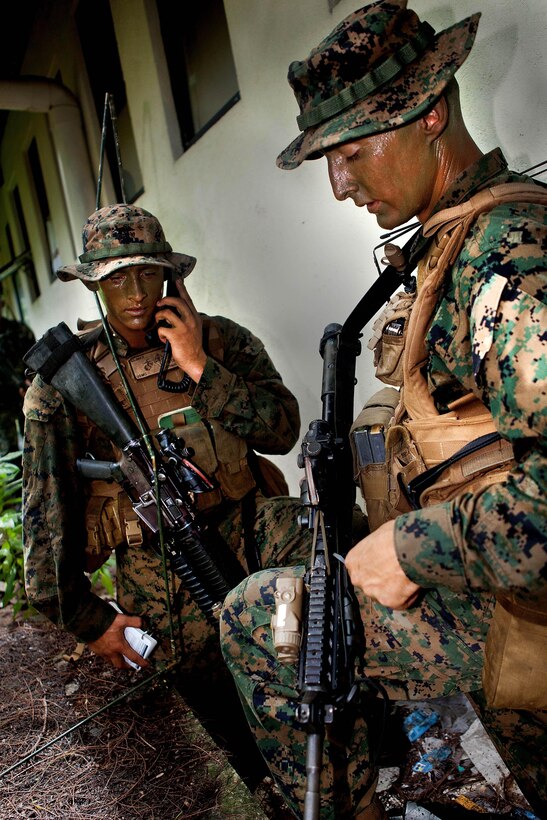 Lance Cpl. Clayton Climer, rifleman, and Staff Sgt. Jeremy Ludwig, platoon sergeant, both with Company A, 1st Battalion, 4th Marine Regiment, call in a "9-line" medical evacuation request (MEDEVAC) during a raid here Oct. 16 as part of Exercise Coconut Grove 2012. The exercise is a bilateral training event conducted bi-annually between the U.S. Marine Corps and the Maldivian National Defense Force.