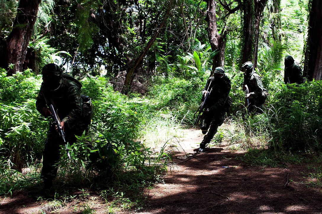 A fire team of Maldivian Marines conduct a raid here Oct. 16 as part of Exercise Coconut Grove 2012. The exercise is a bilateral training event conducted bi-annually between the U.S. Marine Corps and the Maldivian National Defense Force.