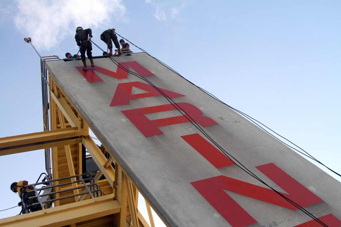 Recruits of Company G, 2nd Recruit Training Battalion, descends from a 60-foot rappel tower Oct. 19 aboard Marine Corps Recruit Depot San Diego. Rappeling is a controlled descent from a great height using a harness and ropes as a pulley system.