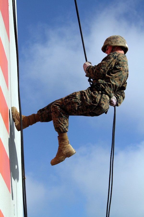 A recruit of Company G, 2nd Recruit Training Battalion, descends from a 60-foot rappel tower Oct. 19 aboard Marine Corps Recruit Depot San Diego. Rappeling is a controlled descent from a great height using ropes and a harness as a pulley system. Recruits gain confidence and overcome fear as they learn to trust their ability to correctly rappel and trust their gear.