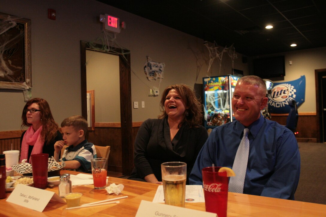Gunnery Sgt. Todd A. McFarland, right, and his wife Talina enjoy a joke told by Gary Baldree, the director of the Havelock Military Affairs Committee at a ceremony in Havelock Wednesday. The McFarlands were recognized as the committee's Family of the Quarter based on the entire family’s willingness to go above and beyond to serve their community.


