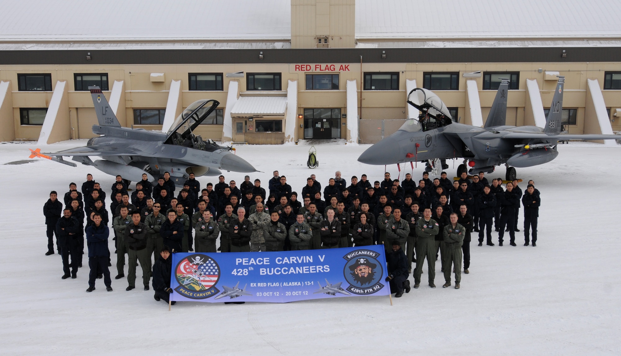 Personnel from the 428th Fighter Squadron pose for a group photo on the final day of the RED FLAG-ALASKA 13-1 exercise Oct19, 2012 at Eielson Air Force Base, Alaska. The 428th FS "Buccaneers" are stationed at Mountain Home Air Force Base, Idaho, as part of a unique, long-term partnership with the Republic of Singapore Air Force and have spent the past two weeks training in a simulated combat environment. (U.S. Air Force photo/Senior Airman Benjamin Sutton)  
