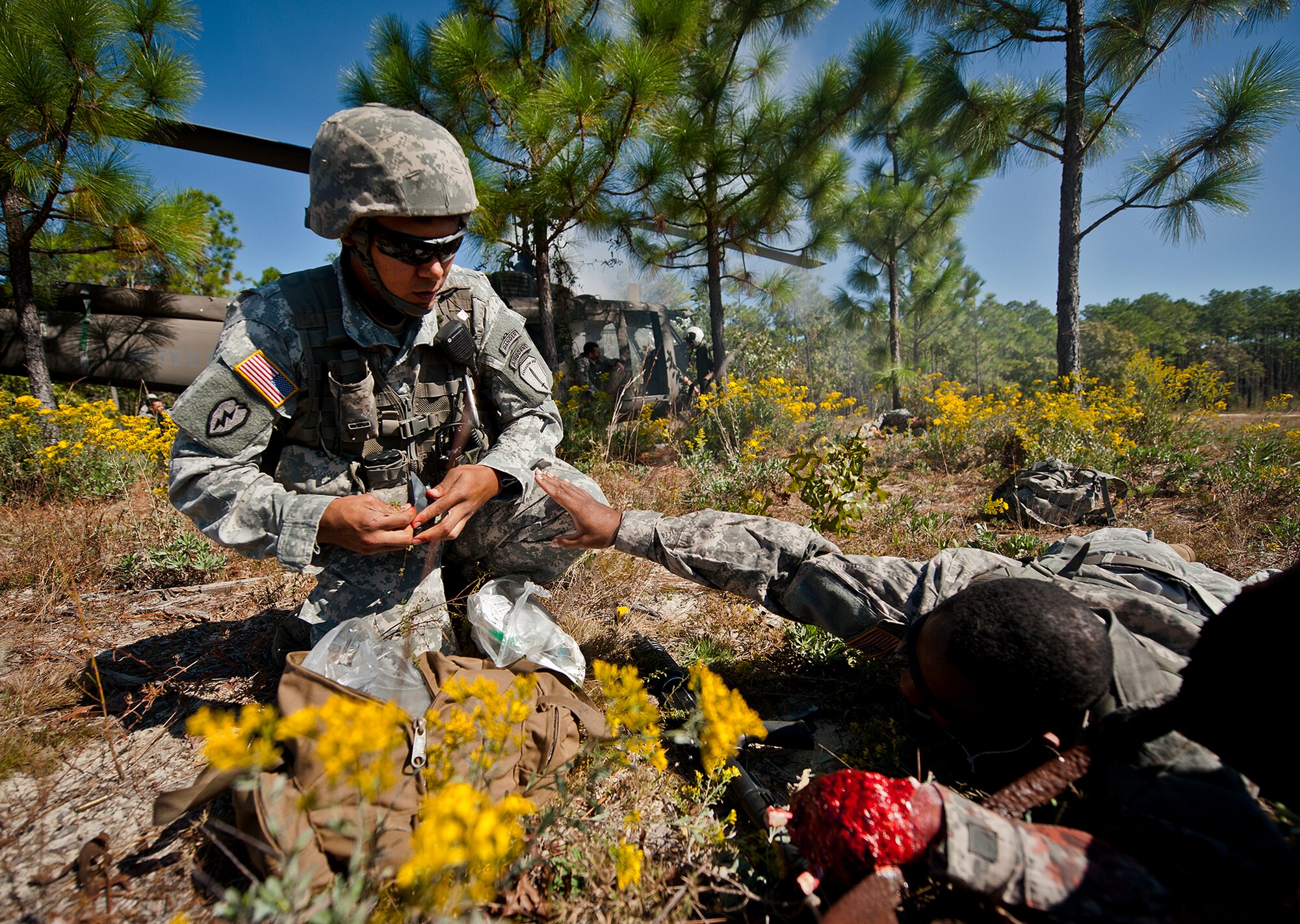 A victim reaches for Sgt. 1st Class Brian Thomas, of the 6th Ranger Training Battalion, to help him after a simulated helicopter crash during an exercise on the Eglin range, Oct. 20.  The 6 RTB, Team Eglin’s emergency responders and local medical facilities participated in the exercise that simulated a downed aircraft with 12 Soldiers injured deep within the Eglin range.  The victims were either evacuated by helicopter or by ambulance to area hospitals.  The annual exercise was to validate the battalion’s emergency procedures and test their communication with Team Eglin and local emergency and medical units.  (U.S. Air Force photo/Samuel King Jr.)