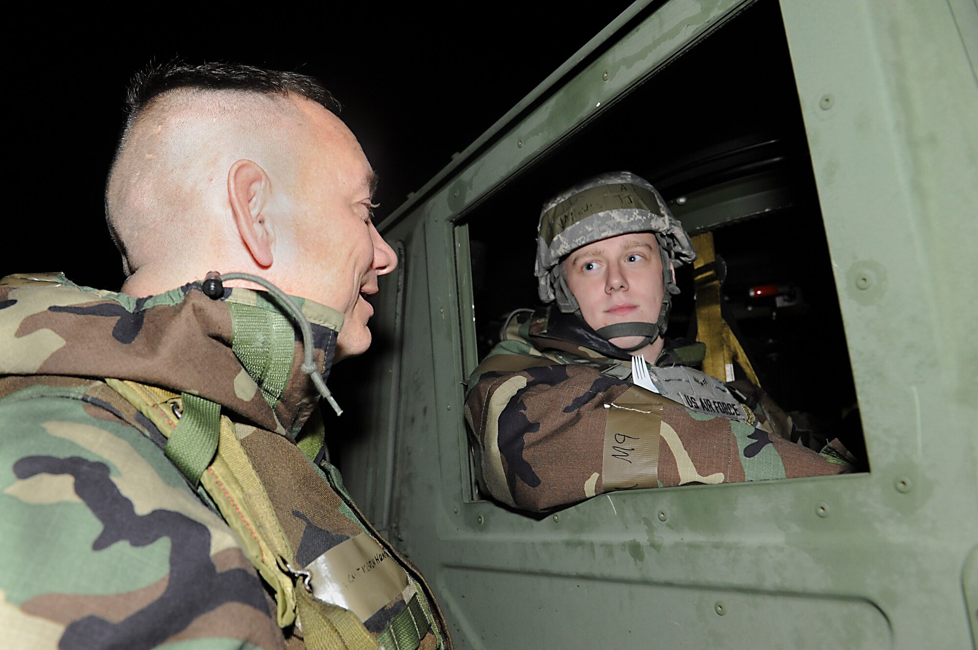 U.S. Air Force Capt. Kevin Humphrey, a Kadena Protestant chaplain, talks with Airman 1st Class Tim Vanhulst, 18th Security Forces Squadron response force member, during Exercise Beverly Bearcat 12-1 on Kadena Air Base, Japan, Oct. 25, 2012. Chaplains visit members across the base to help boost morale, spiritual guidance and to give the Airmen support. (U.S. Air Force photo/Airman 1st Class Malia Jenkins)    