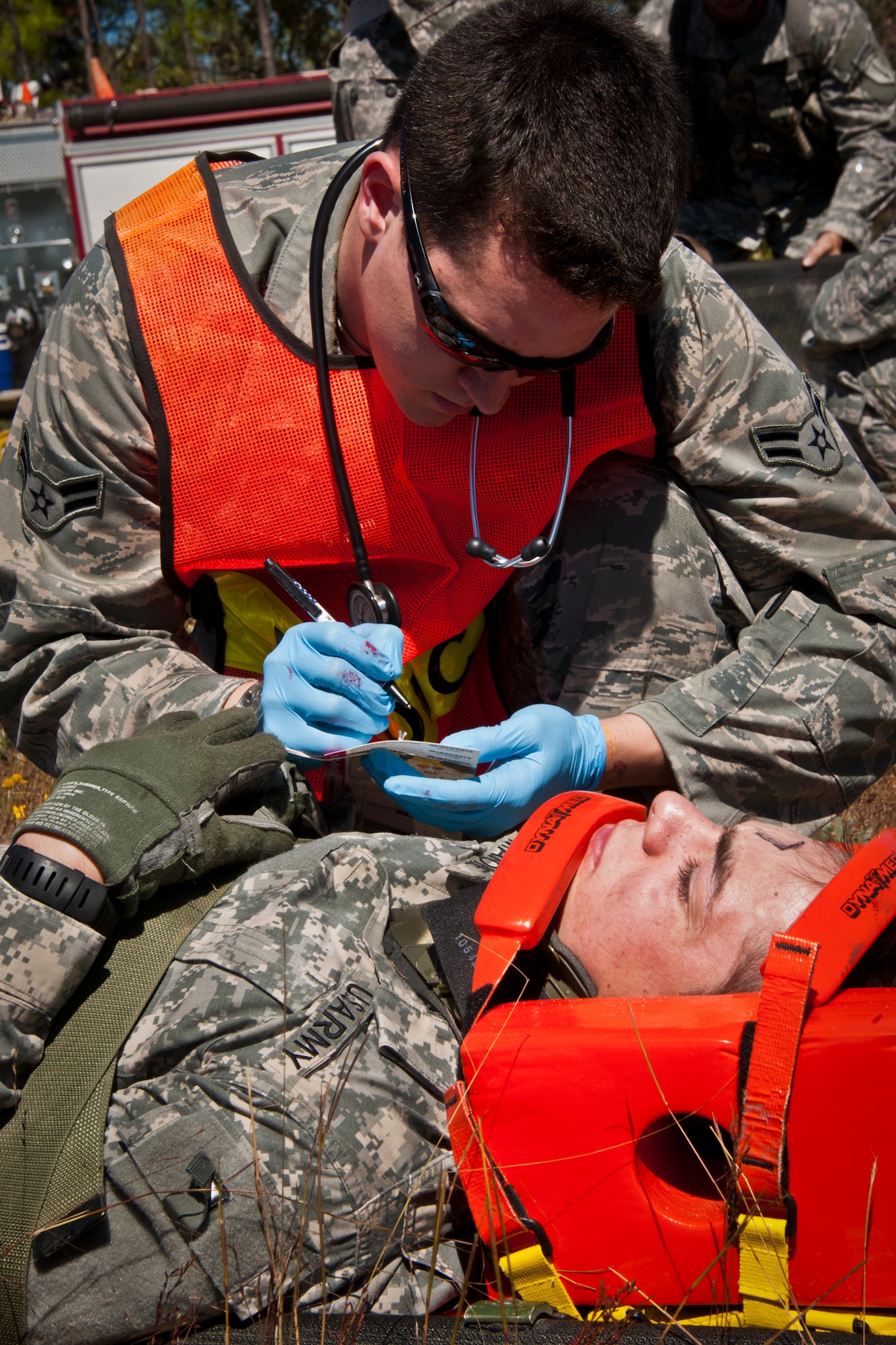 Airman 1st Class Andrew Davis, of the 96th Medical Group, fills out an injury card for a simulated victim during a downed aircraft exercise on the Eglin range, Oct. 20.  The 6th Ranger Training Battalion, Team Eglin’s emergency responders and local medical facilities participated in the exercise that simulated a helicopter crash with 12 Soldiers injured deep within the Eglin range.  The victims were either evacuated by helicopter or by ambulance to area hospitals.  The annual exercise was to validate the battalion’s emergency procedures and test their communication with Team Eglin and local emergency and medical units.  (U.S. Air Force photo/Samuel King Jr.)