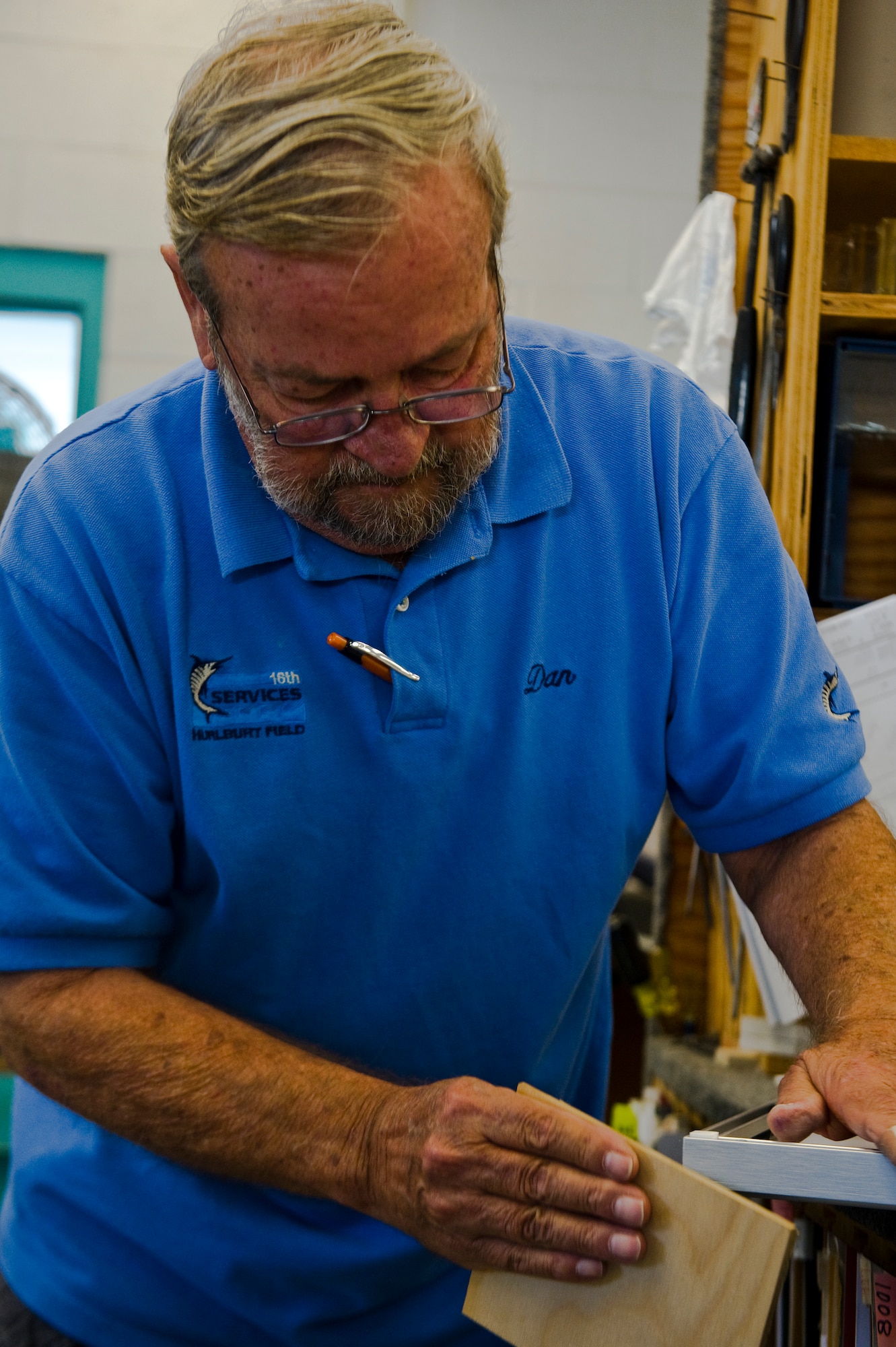 Dan Ruddell, manager of The Frame Shop, sands the corner of a custom frame that is in the final process of being finished at The Frame Shop on Hurlburt Field, Fla., Oct. 12, 2012. The shop comes equipped with metal and wood frames in a large selection of materials and colors, foam-core back-boards, frame hardware and a variety of glass which includes standard and non-glare glass.  (U.S. Air Force photo/Airman 1st Class Christopher Williams)
