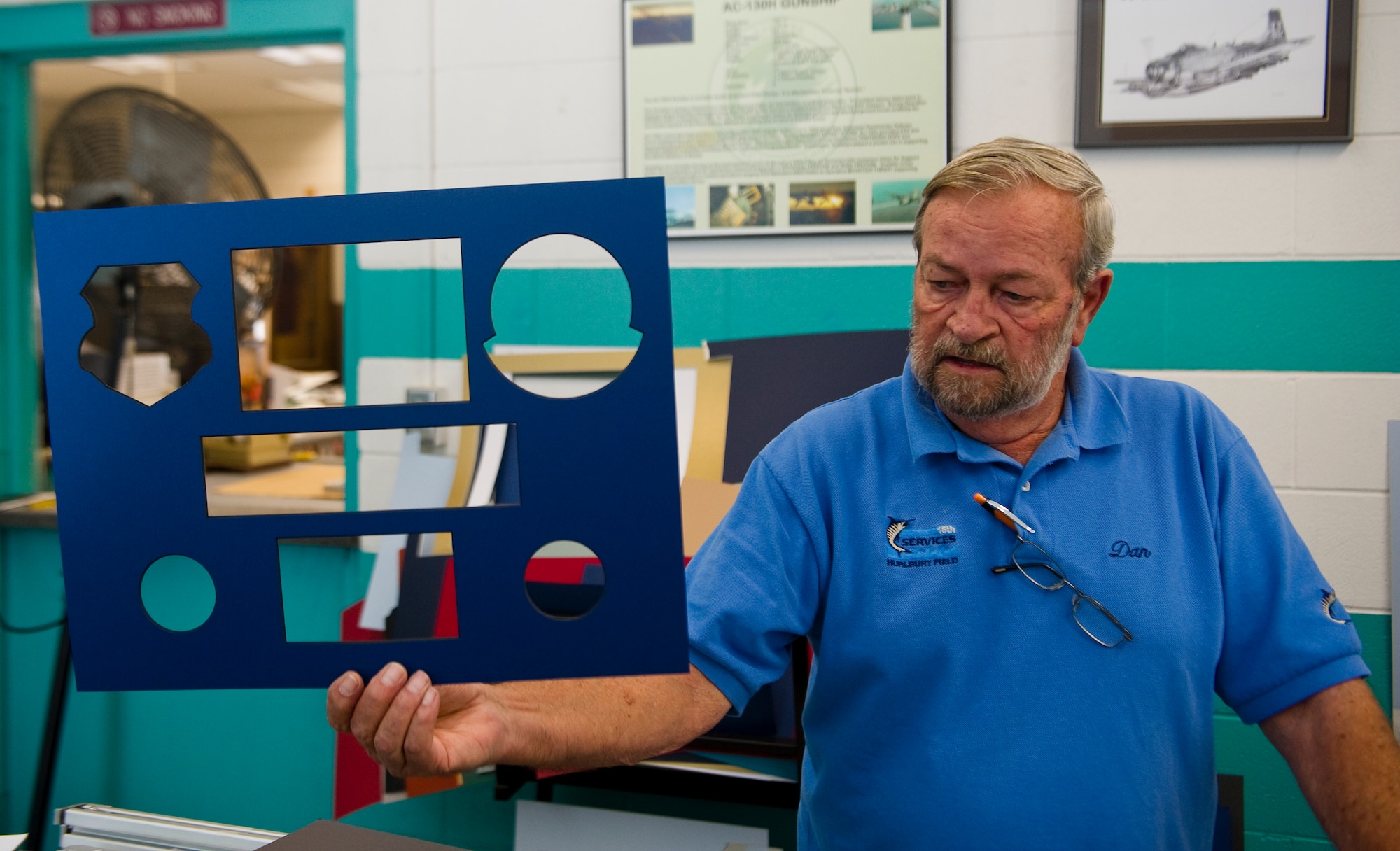 Dan Ruddell, manager of The Frame shop, holds up a final foam-board cut out that he just finished working on at The Frame Shop on Hurlburt Field, Fla., Oct. 12, 2012. The frame shop comes equipped with metal and wood frames in a large selection of materials and colors, foam-core back-boards, frame hardware and a variety of glass which includes standard and non-glare glass. (U.S. Air Force photo/Airman 1st Class Christopher Williams)
