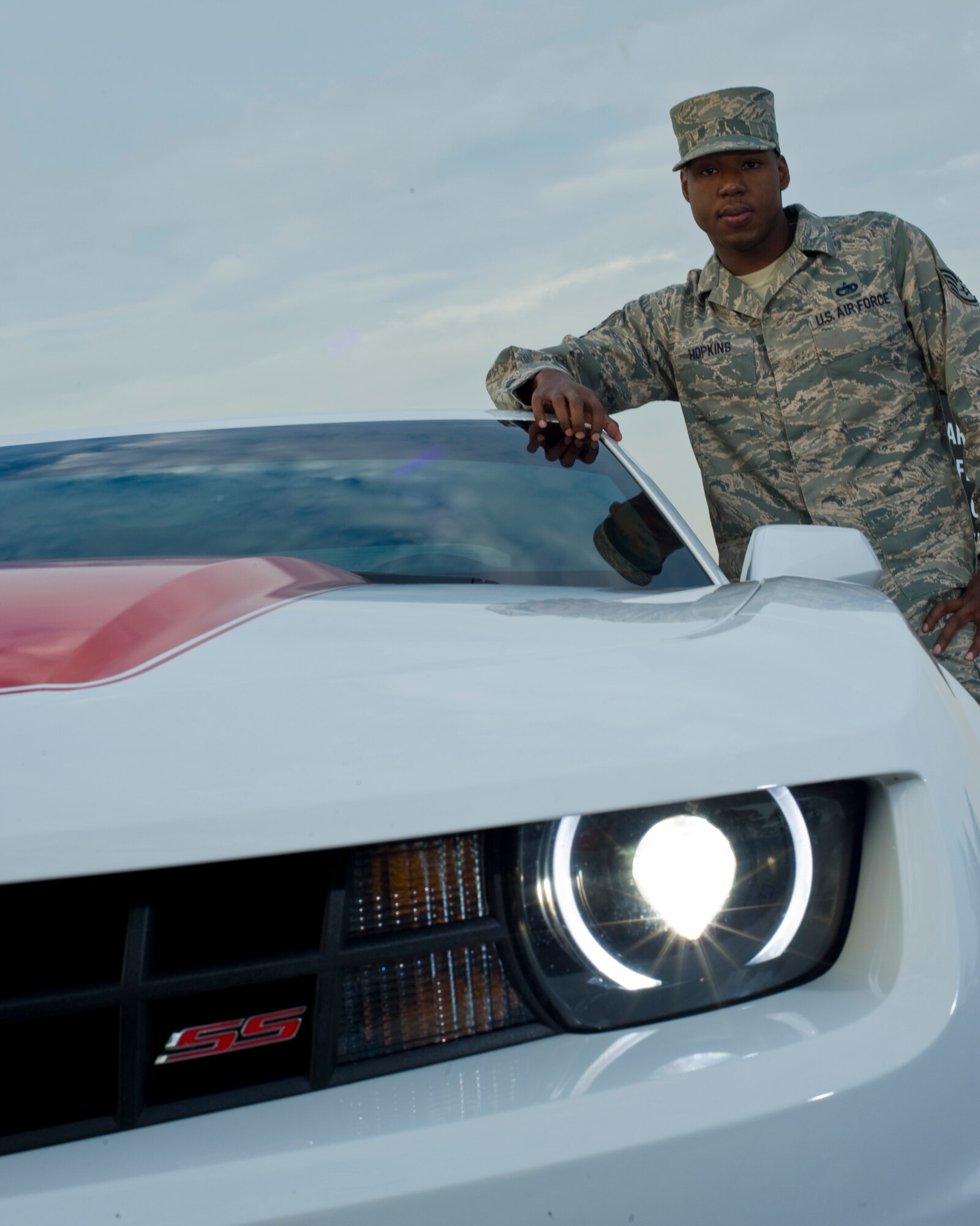 U.S. Air Force Staff Sgt. Dwayne Hopkins, a unit deployment manager with 1st Special Operations Logistics Readiness Squadron, stands next to his Camaro SS on Hurlburt Field Fla., Oct. 3, 2012. He is a member of the Airman to Airman Saftey Advisory Council; Hopkins has been briefing a safety message based on the lessons he learned after a motorcycle accident. (U.S. Air Force Photo / Staff Sgt. John Bainter)