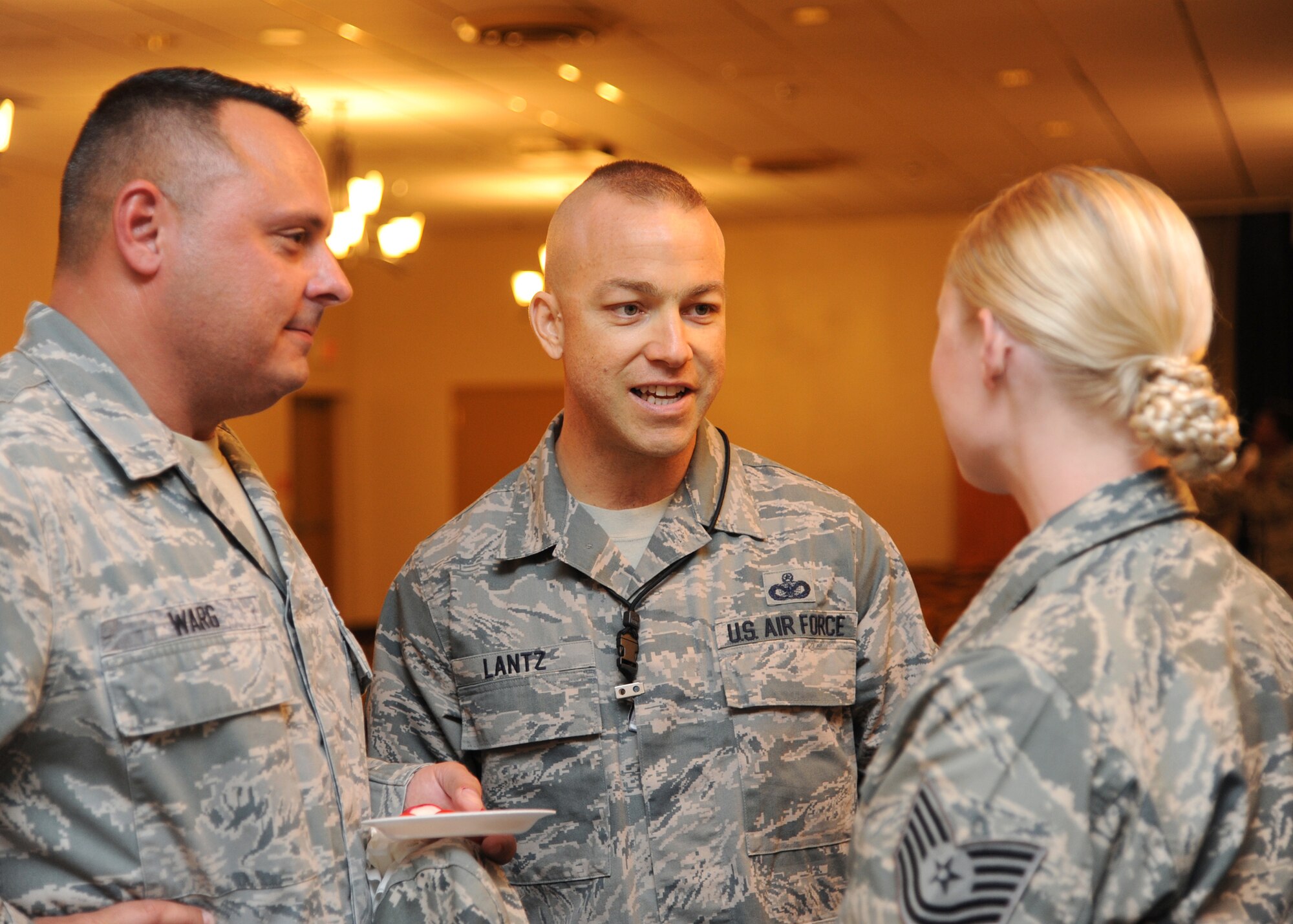Senior Master Sgt. Frank Warg, Headquarters Air Force Global Strike Command Logistics Plans Functional Manager, Chief Master Sgt. Michael Lantz, HQ AFGSC First Sergeant, speak with Tech. Sgt. Angela Pursley, HQ AFGSC Logistics Planner and Integration, during a team building exercise at a HQ AFGSC enlisted all call Oct. 23. Chief Lantz, who is relatively new to the headquarters staff, said his primary reason for doing the exercise is for Airmen on the staff to get to know each other better. He said as he makes his rounds, he realizes how compartmentalized the staff is and, by getting everyone together, the goal was to open up lines of communication and make connections with other staff agencies. (U.S. Air Force photo/Airman 1st Class Joseph A. Pagán Jr.)(RELEASED)