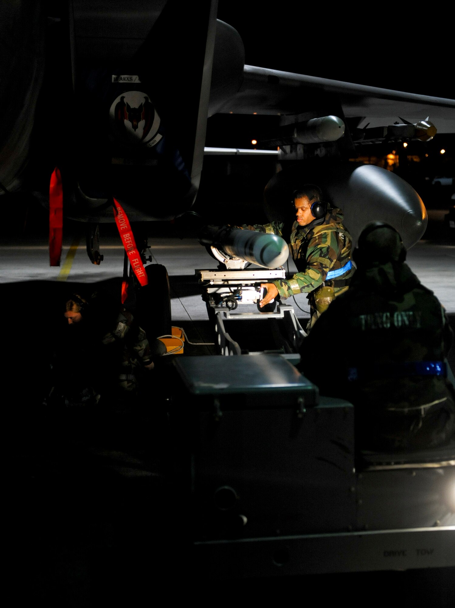 U.S. Air Force Staff Sgts. Megan Stephens and Jared Hall, 44th Aircraft Maintenance Unit weapons load crew technicians, load weapons onto an F-15C Eagle during Exercise Beverly Bearcat 12-1, an operational readiness inspection on Kadena Air Base, Japan, Oct. 25, 2012. Readiness inspections evaluate the ability of Air Force units to respond to a wide range of contingencies. (U.S. Air Force photo/Airman 1st Class Justin Veazie)