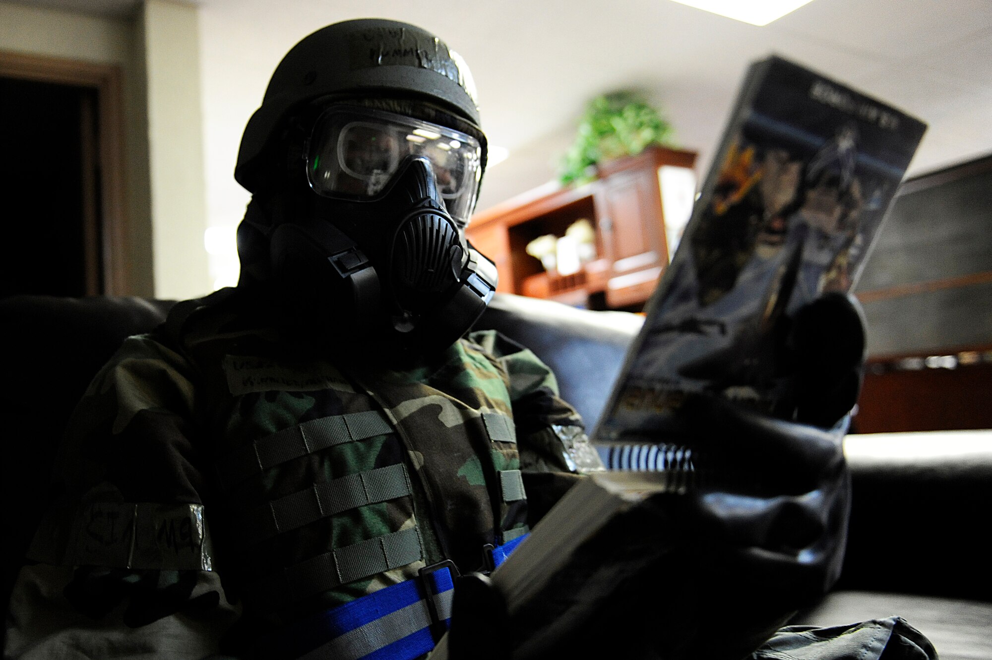 U.S. Air Force Airman 1st Class Michael Kummer reviews an Airman’s Manual while in Mission-Oriented Protective Posture gear following a simulated attack on the base as part of Exercise Beverly Bearcat 12-1, an operational readiness inspection on Kadena Air Base, Japan, Oct. 24, 2012. Kummer is a 18th Force Support Squadron food services specialist working at the Kadena mortuary. During the inspection, Airmen are tested on their ability to survive and operate in a number of scenarios ranging from fire response to missile attacks in order to train and prepare for potential real-world contingencies. Though Kadena doesn’t normally accommodate mortuary affairs, during contingency operations, the 18th FSS establishes a mortuary on base in order to provide quicker response following an attack. (U.S. Air Force photo/Senior Airman Maeson L. Elleman)