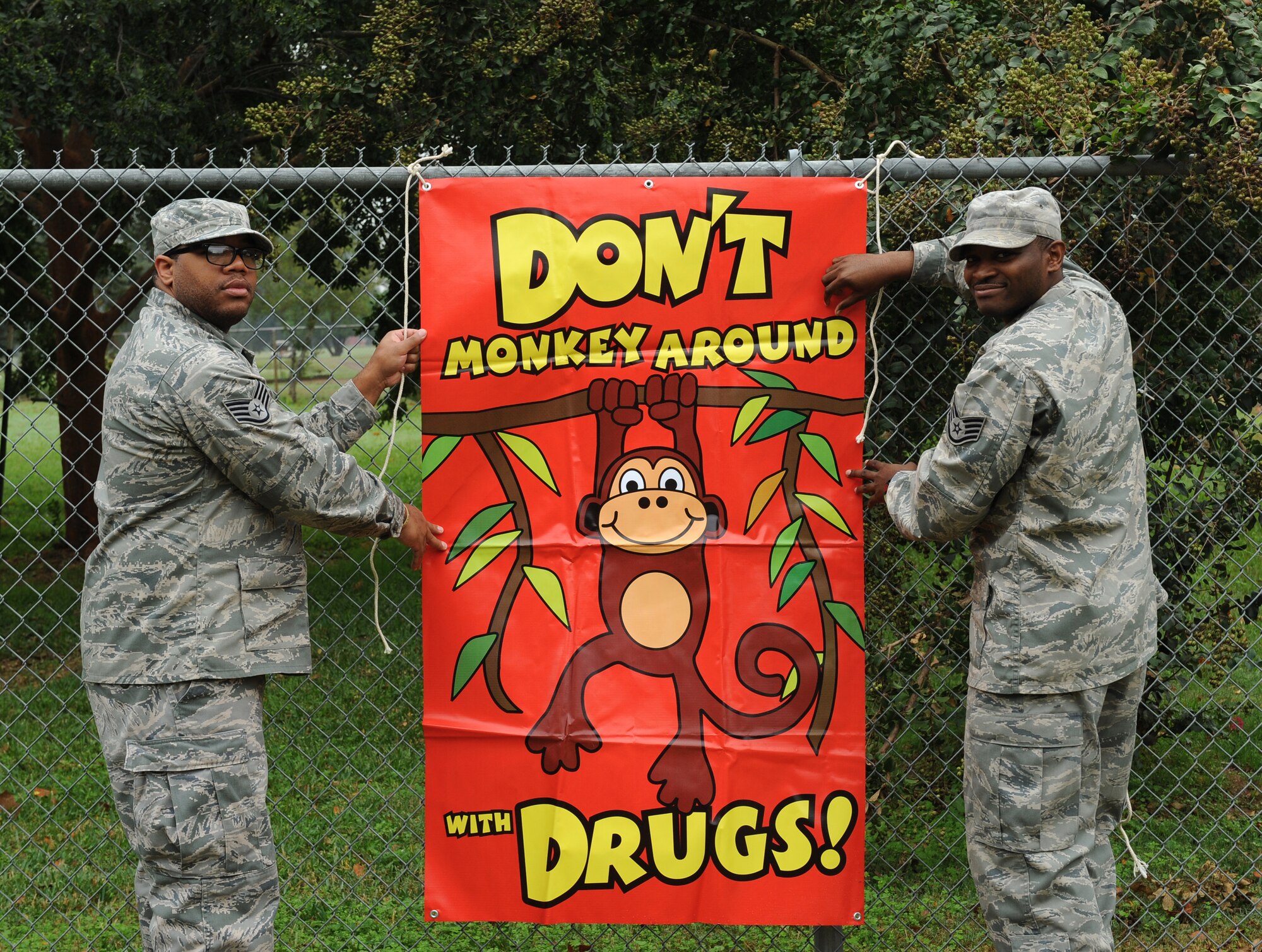 Staff Sgt. Norris Jamison, left, 2nd Medical Operations Squadron Alcohol and Drug Abuse Prevention and Treatment NCO in charge, and Staff Sgt. Brandon Woods, 2 MDOS ADAPT technician, hang a poster during Red Ribbon Week on Barksdale Air Force Base, La., Oct. 24. Red Ribbon Week is celebrated annually Oct. 23-31 to inform the community of drug and alcohol abuse. Barksdale Airmen are participating by visiting local schools to educate students on healthy lifestyle choices and the negative effects of drug and alcohol abuse. (U.S. Air Force photo/Airman 1st Class Benjamin Gonsier)(RELEASED)
