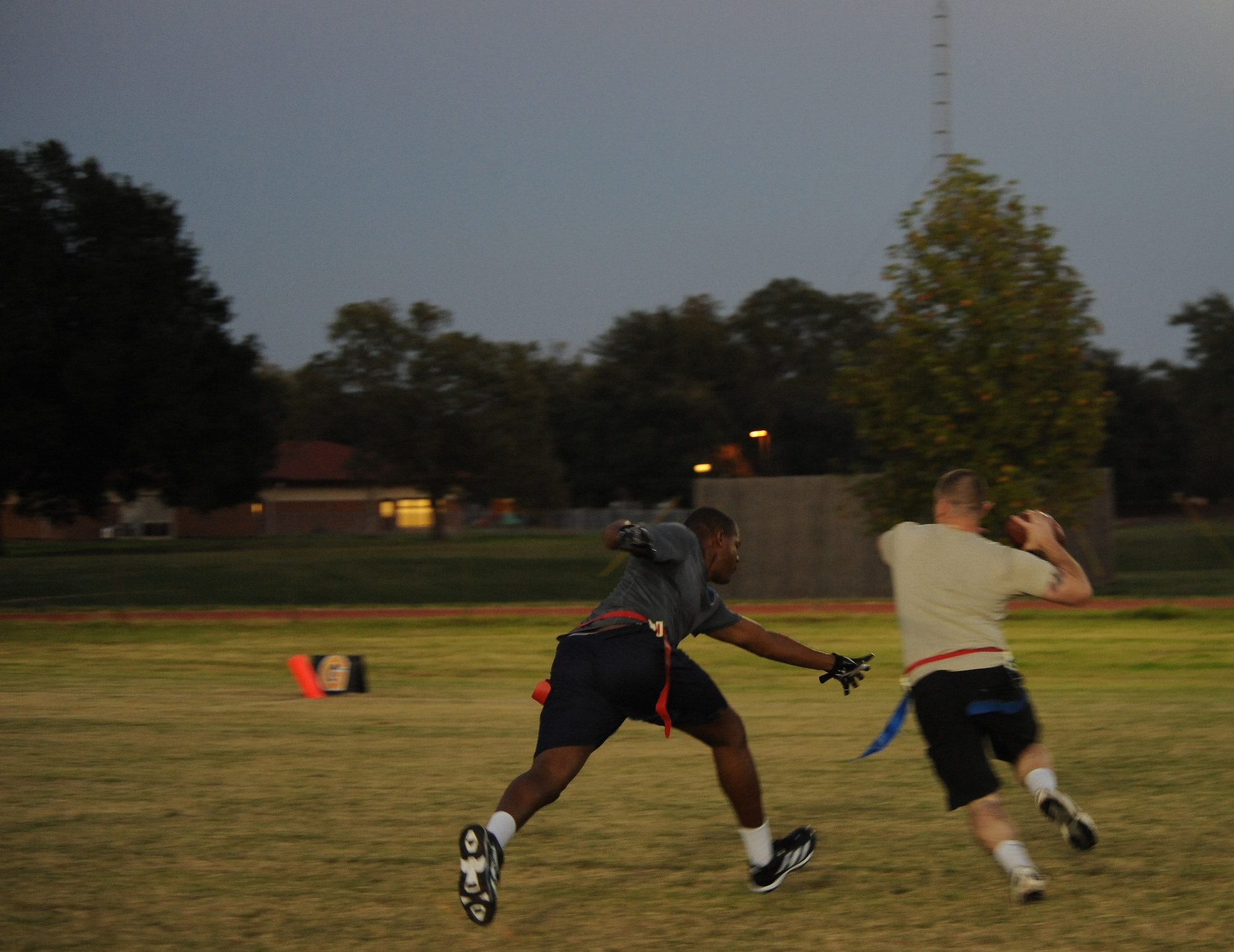 A Barksdale Airman tries to grab a flag from the opposing team's quarterback during a flag football scrimmage on Barksdale Air Force Base, La., Oct. 23. The Barksdale Fitness Center is hosting a flag football league where Barksdale Airmen team up and compete against each other. The league consists of 15 teams and games are played Monday to Thursday. (U.S. Air Force Photo/Airman 1st Class Benjamin Gonsier)(RELEASED)  
