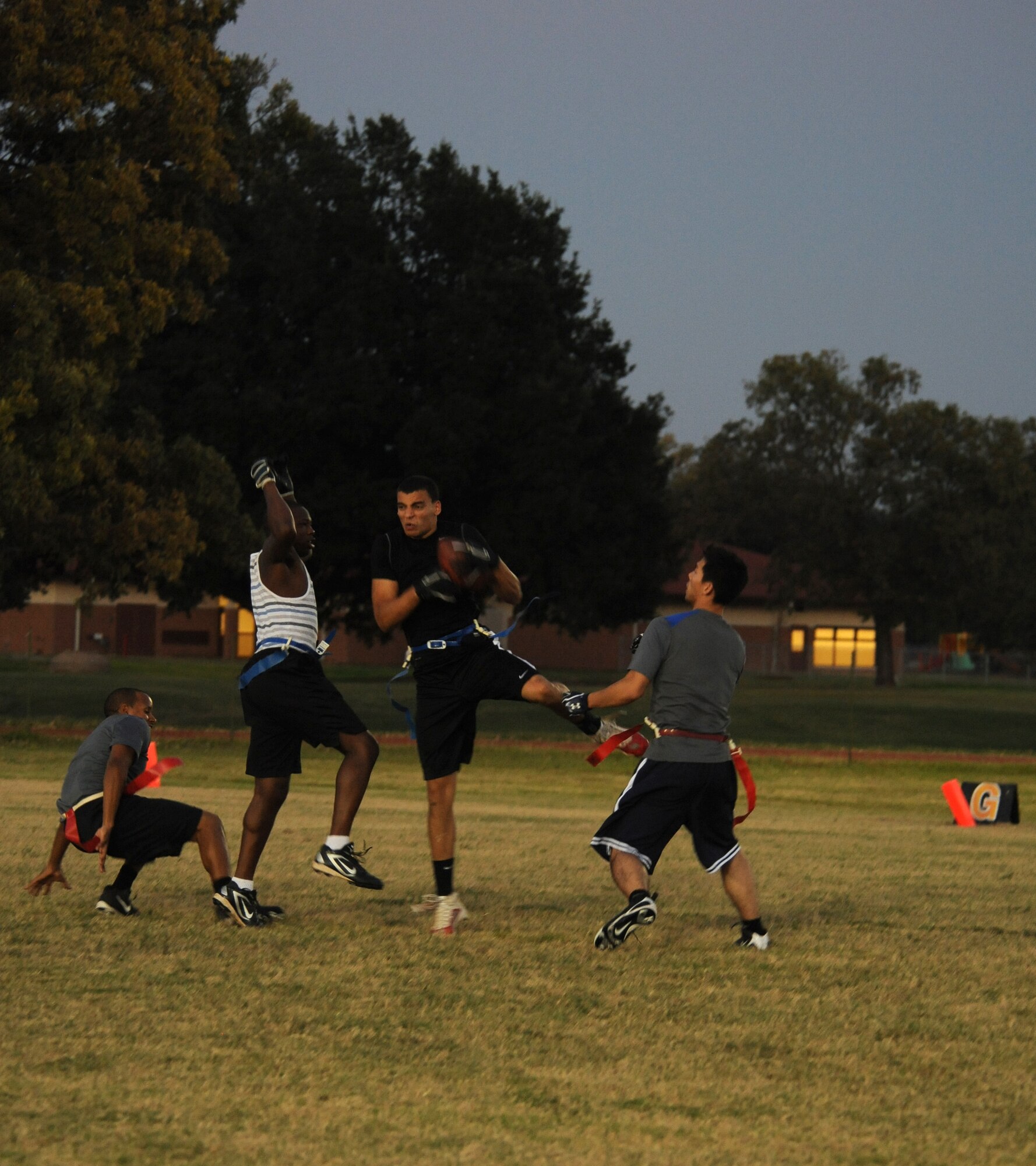 A Barksdale Airman catches a football during a flag football scrimmage on Barksdale Air Force Base, La., Oct. 23. The Barksdale Fitness Center is hosting a flag football league where Barksdale Airmen team up and compete against each other. The league consists of 15 teams and games are played Monday to Thursday. (U.S. Air Force Photo/Airman 1st Class Benjamin Gonsier)(RELEASED)  