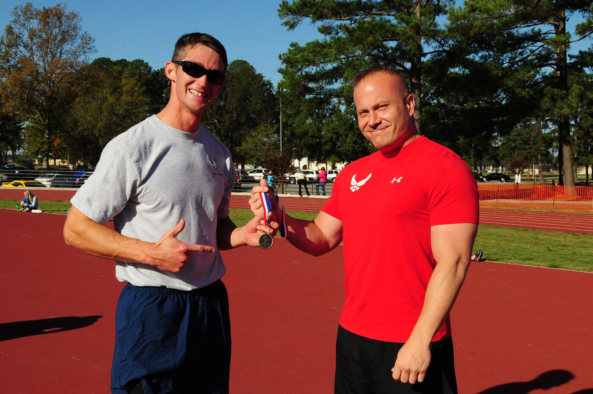 U.S. Air Force Staff Sgt. Brendan Manley-Bryant, 333rd Aircraft Maintenance Unit dedicated crew chief, receives a medal from Mike Unden, 4th Force Support Squadron military fitness specialist, after the Combat Fitness Challenge on Seymour Johnson Air Force Base, N.C., Oct. 20, 2012. Manley-Bryant took first place in the challenge with a time of 27 minutes. (U.S. Air Force photo/Airman 1st Class Aubrey White/Released)