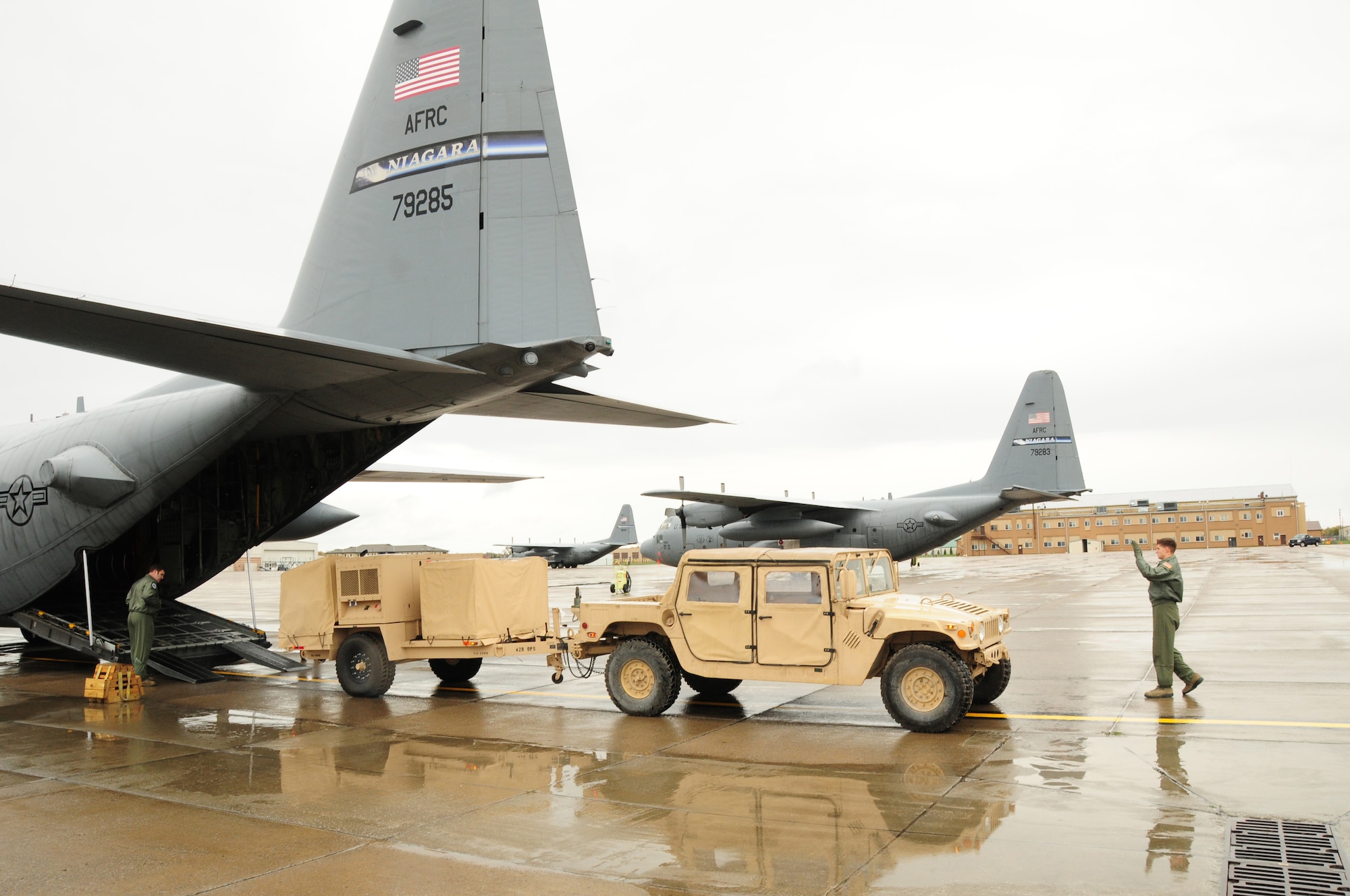 The operational company of the 42nd Infantry Division of the Army National Guard arrived ready to train with the 107th Airlift Wing's C-130 loadmasters. Airman 1st Class Limina guides the High Mobility Multipurpose Wheeled Vehicle (HMMWV), onto the C-130 aircraft. Army Guard Sgt. Albi is behind the wheel of the HMMWV. Oct. 20, 2012 (U.S. Air Force Photo/Senior Master Sgt. Ray Lloyd)
