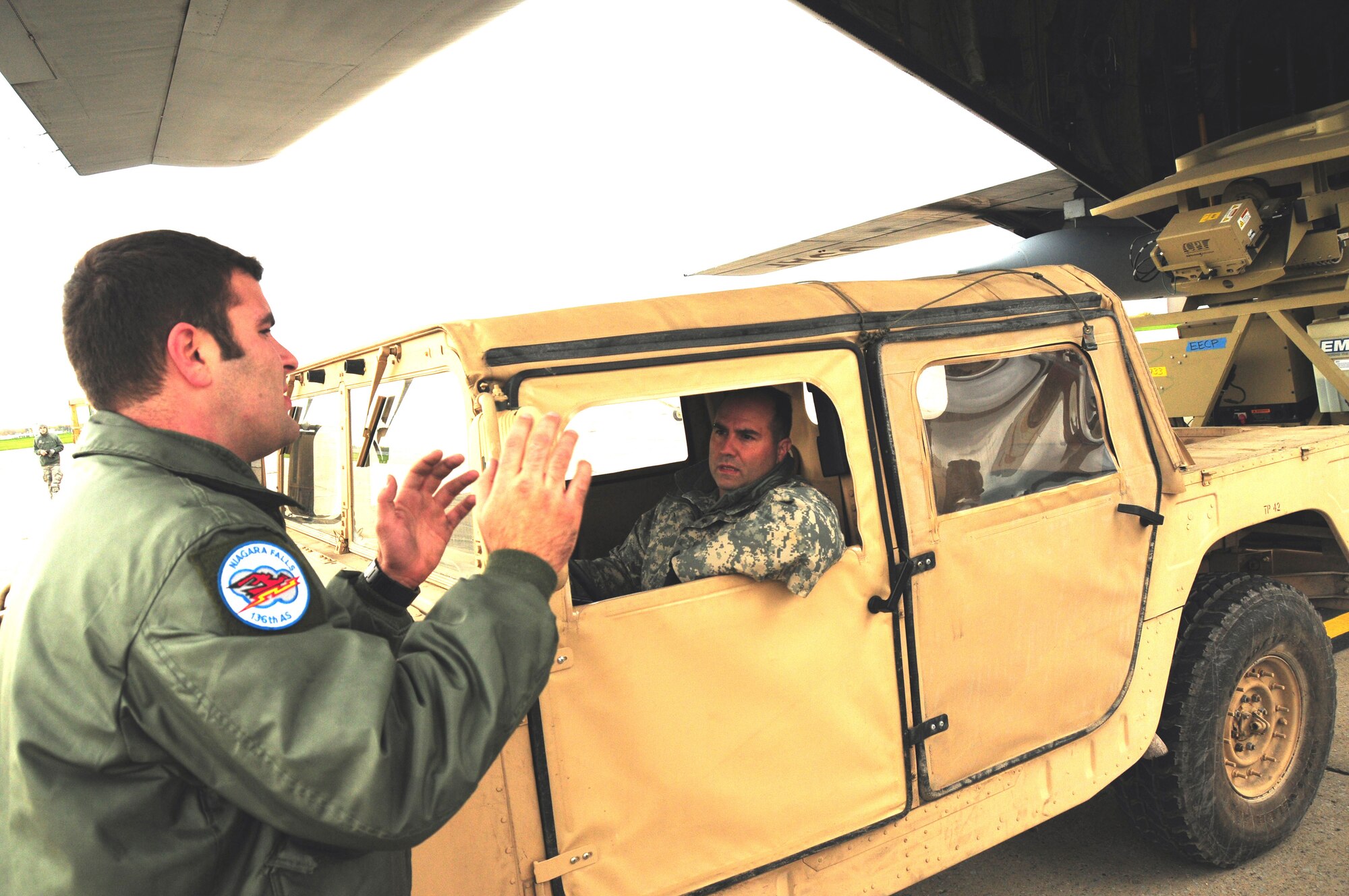 The Operational Company of the 42nd Infantry Division of the Army National Guard arrived ready to train with the 107th Airlift Wing's C-130 loadmasters. Senior Airman Babirad guides the AN/TSC-185 Satellite Vehicle onto the C-130 aircraft. Army Guard Sgt. 1st Class Anzalone is  behind the wheel of the HMMWV.
Oct. 20, 2012 (U.S. Air Force Photo/Senior Master Sgt. Ray Lloyd)

