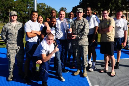 Colonel Richard McComb, Joint Base Charleston commander, presents Dorm 473 Airmen a trophy after the Dorm Challenge basketball championship game Oct. 19, 2012, at Joint Base Charleston - Air Base, S.C. Dorm 473 Airmen received the most points in all the competition’s categories: education, volunteerism, dorm inspection, and fitness. (U.S. Air Force photo/ Airman 1st Class Chacarra Walker)