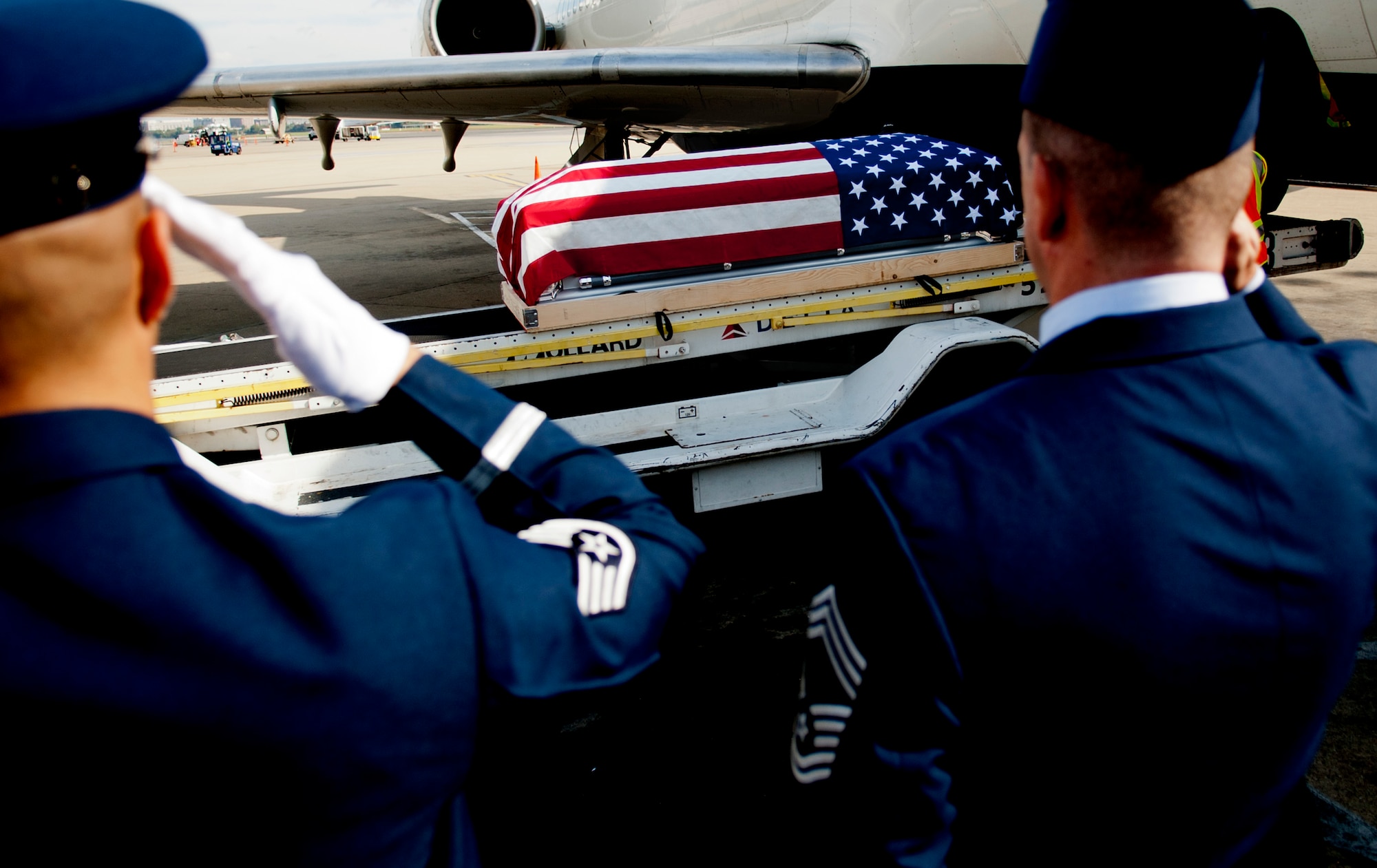 U.S. Airmen salute as the remains of Col. Wendell Keller, of Fargo N.D. and Capt.Virgil K. Meroney, of Fayetteville, Ark., arrive in a casket draped with the U.S. Flag at Ronald Reagan Washington National Airport Oct. 18, 2012. The U.S. Air Force Honor Guard and family members were present at the arrival. March 1, 1969, Keller and Meroney were the crew of an F-4D Phantom II aircraft that went down while carrying out a night time strike mission in Khammouan Province, Laos. Nearby aircrews reported seeing the aircraft hit by enemy fire. No parachutes were seen after the aircraft was hit. Heavy enemy presence in the area prevented recovery efforts.  (U.S. Air Force photo/Master Sgt. Cecilio Ricardo)