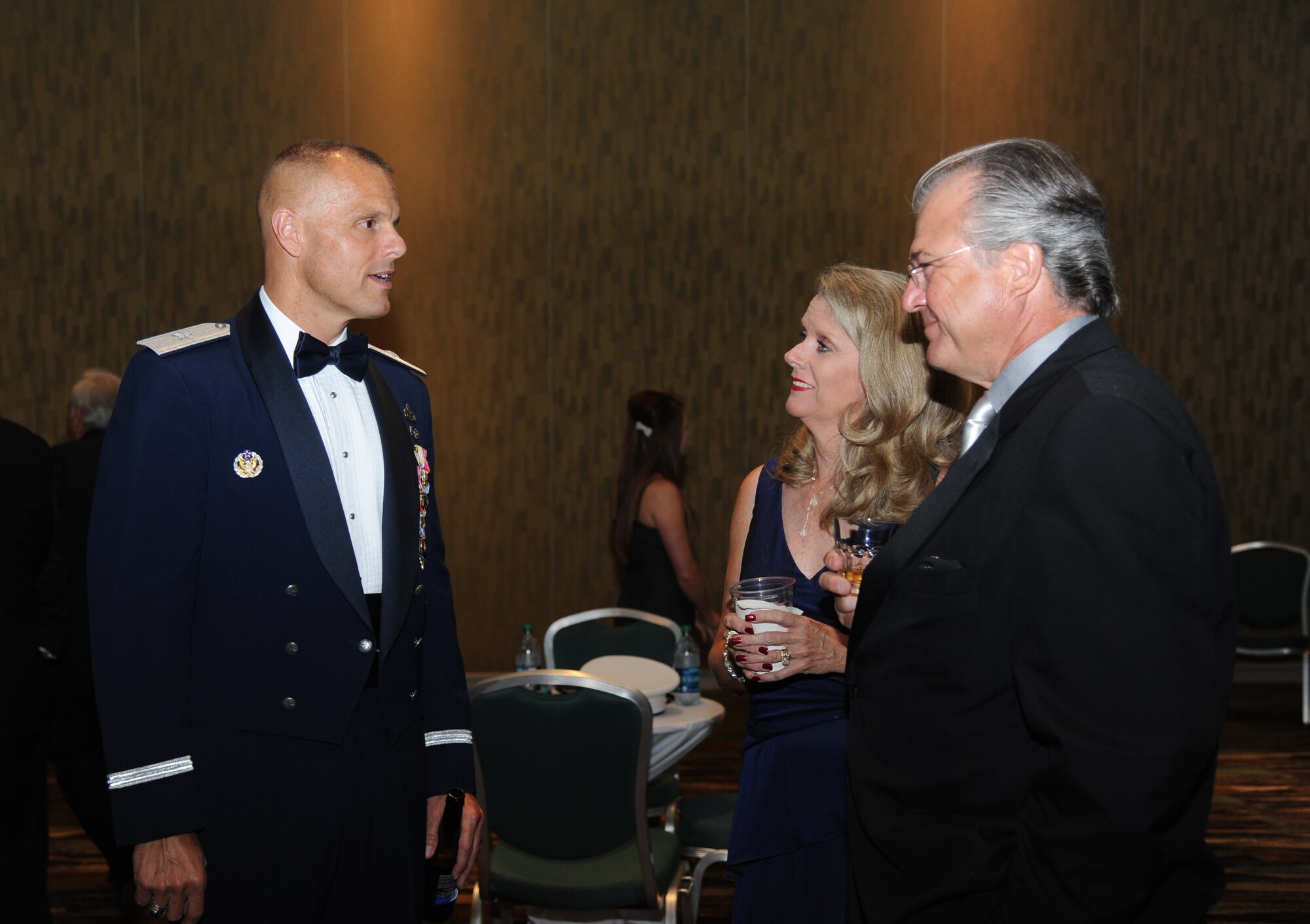 Brig. Gen. Brad Spacy, 81st Training Wing commander, Keesler Air Force Base, Miss., mingles with Margaret and Duncan McKenzie, Hard Rock Casino general manager, during the reception at the 34th Annual Salute To The Military Oct. 23, 2012, at the Mississippi Coast Coliseum in Biloxi.  (U.S. Air Force photo by Kemberly Groue)