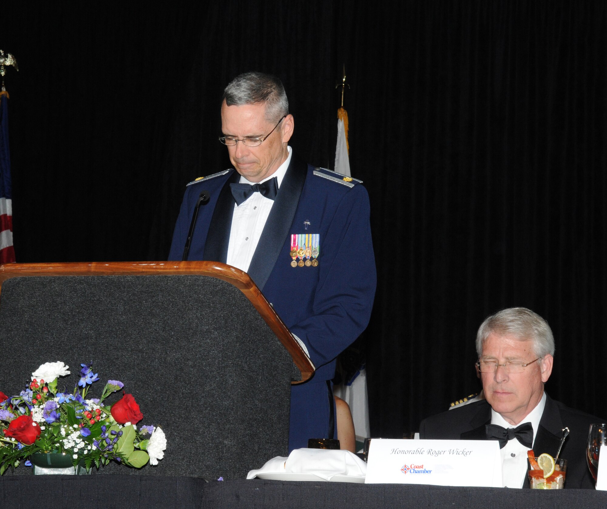 The Honorable Roger Wicker, United States Senate, bows his head as Chaplain (Maj.) Mark Thomas, 81st Training Wing, Keesler Air Force Base, Miss., delivers the invocation for the 34th Annual Salute To The Military Oct. 23, 2012, at the Mississippi Coast Coliseum in Biloxi.  (U.S. Air Force photo by Kemberly Groue)
