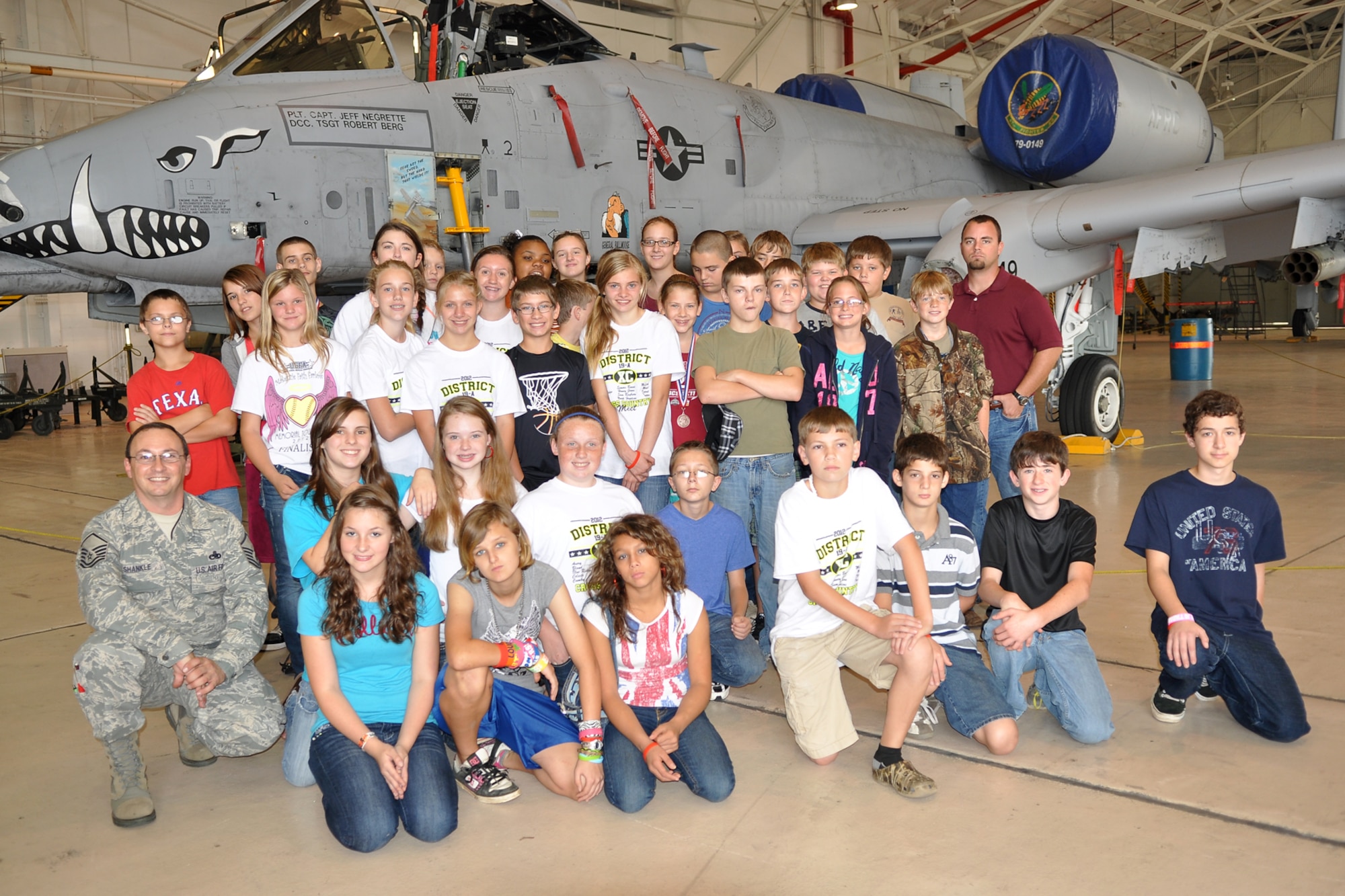 Master Sgt. John Shankle, a flight line expediter assigned to the 917th Aircraft Maintenance Squadron, poses for a photo in front of an A-10 Thunderbolt II with a group of 7th Graders, at Barksdale Air Force Base, La., Oct. 23, 2012. The students who are from McLeod, Texas, attend McLeod Middle School and were touring the base as part of a field trip. Many of the 44 students were unaware there was a military base in Bossier City. The students also toured a 307th Bomb Wing B-52 Stratofortress and the Military Working Dog Training Facility here. They also visited the Barksdale Global Power Museum. (U.S. Air Force photo by Betty Stephens/Released)