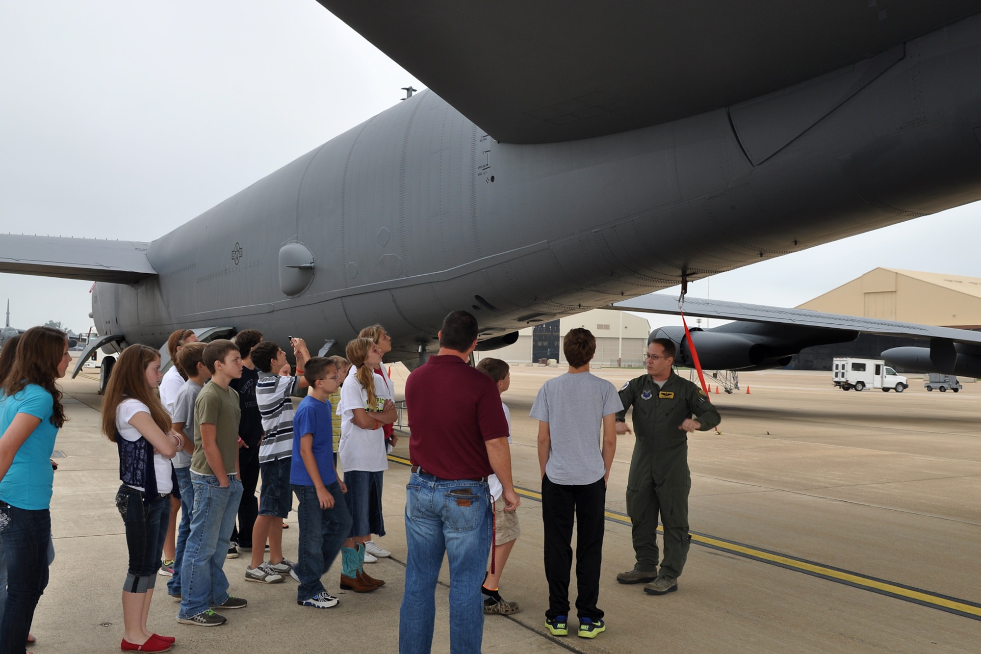 Maj. Glenn Auge, instructor radar navigator, 11th Bomb Squadron, explains the war-time capabilities of a B-52 Startofortress to a group of 7th Grade students during a static tour at Barksdale Air Force Base, La., Oct. 23, 2012. The students who are from McLeod, Texas, attend McLeod Middle School and were touring the base on a field trip. Many of the 44 students were unaware there was a military base in Bossier City. The students also toured a 917th Fighter Group A-10 Thunderbolt II and the Military Working Dog Training Facility here. They also visited the Barksdale Global Power Museum. (U.S. Air Force photo by Betty Stephens/Released)