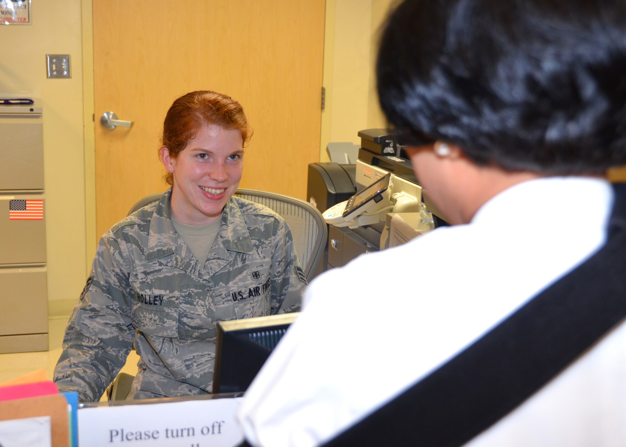 Senior Airman Heather Holley, 81st Medical Operations Squadron, assists a patient in the Family Health Clinic at the Keesler Hospital in January, 2011, at Keesler Air Force Base, Miss. She and her husband Eric, a former Navy corpsman, were able to use their medical training to assist a motorcycle accident victim until first responders arrived.  (U.S. Air Force photo by Steve Pivnick)