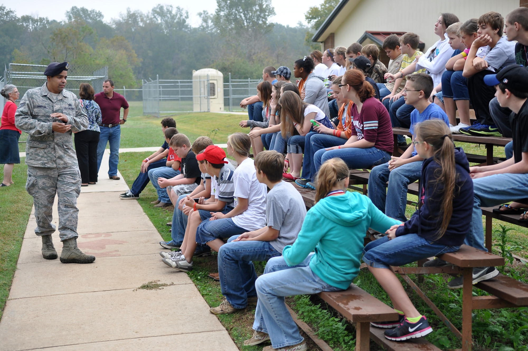 Staff Sgt. Erik Santos, who is a military working dog trainer assigned to the 2nd Security Forces Squadron, briefs a group of 7th Graders at the MWD training area on Barksdale Air Force Base, La., Oct. 23, 2012. The students who are from McLeod, Texas, attend McLeod Middle School and were touring the base as part of a field trip. Many of the 44 students were unaware there was a military base in Bossier City. The students also toured a 307th Bomb Wing B-52 Stratofortress and a 917th Fighter Group A-10 Thunderbolt II. They also visited the Barksdale Global Power Museum. (U.S. Air Force photo by Betty Stephens/Released)