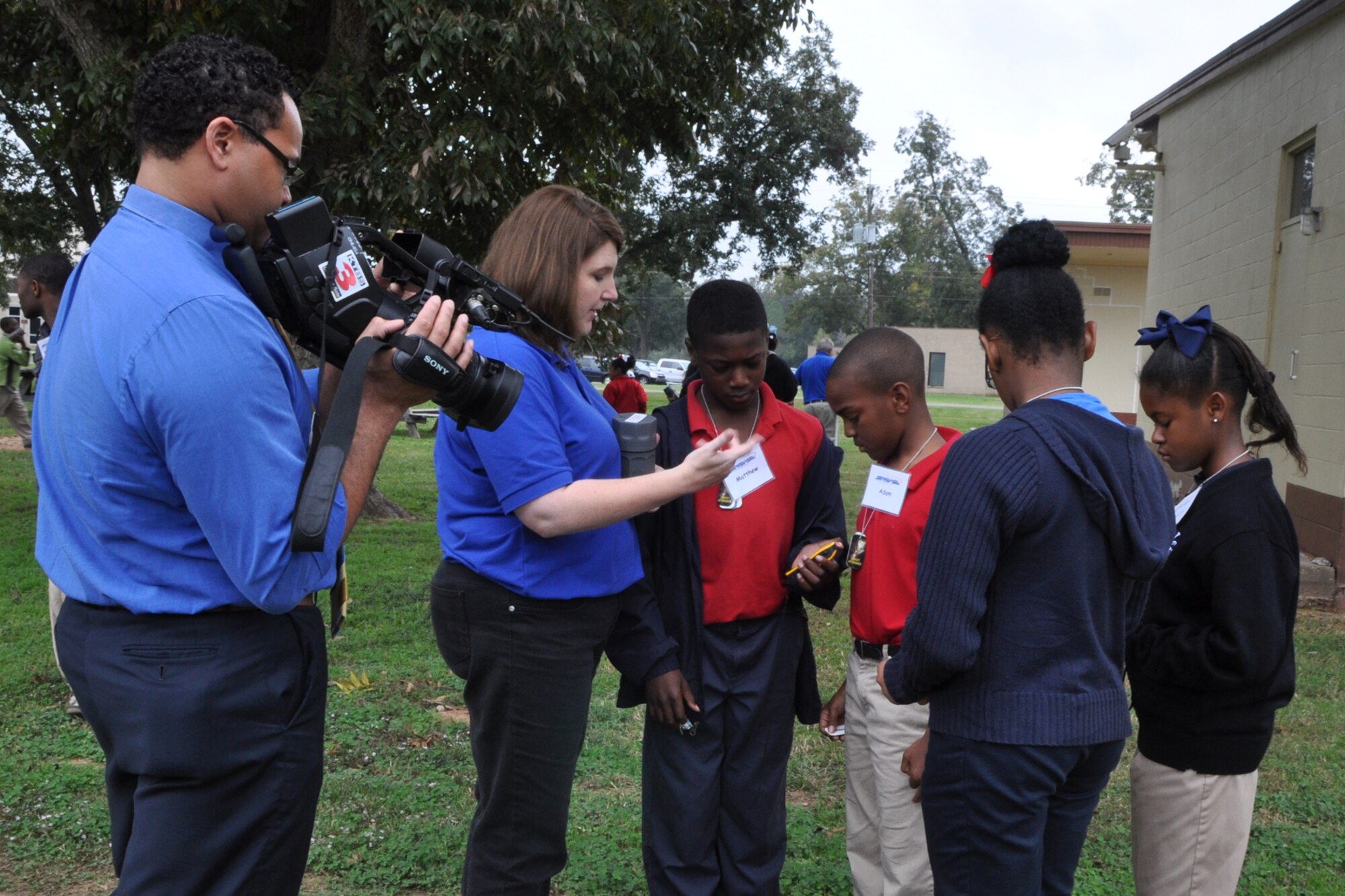 Christy Bucker, technology coordinator/instructor, STARBASE Louisiana, helps students from Claiborne Fundamental Elementary School with a handheld global positioning system at Barksdale Air Force Base, La., Oct. 23, 2012. Eric James, a multimedia journalist with KTBS Channel 3 in Shreveport, La., was on hand to record the activities for a story about Claiborne being selected as a 2012 National Blue Ribbon School by the Department of Education. The U.S. Secretary of Education has recognized 269 schools as 2012 National Blue Ribbon Schools based on their overall academic excellence, or for making progress in improving student academic achievement levels. The Department will honor approximately 219 public and 50 private schools at a recognition ceremony on Nov. 12-13 in Washington, D.C. Claiborne is located in Shreveport, La., and is one of 48 elementary schools in Caddo Parish School District. It is a magnet school that serves 391 students in grades K-5. Magnet schools are public schools that offer a specialized curriculum or educational philosophy, often with a specific focus or theme. (U.S. Air Force photo by Master Sgt. Jeff Walston)

