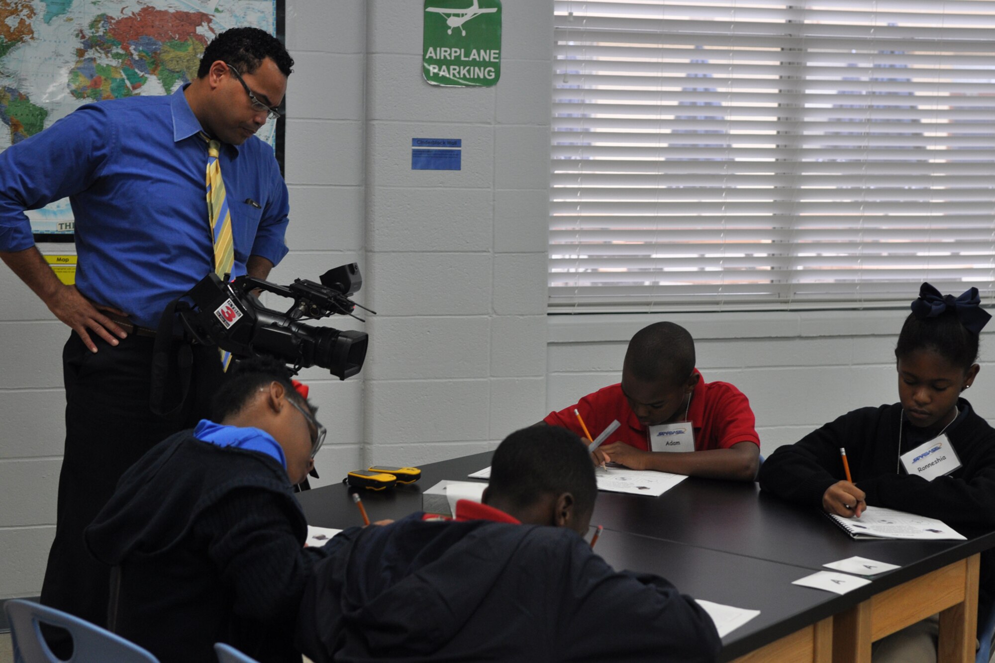 Eric James, a multimedia journalist with KTBS Channel 3 in Shreveport, La., records footage for a news story about the Claiborne Fundamental Elementary School at the STARBASE Louisiana facility on Barksdale Air Force Base, La., Oct. 23, 2012. Claiborne was selected as a 2102 National Blue Ribbon School by the Department of Education.  The National Blue Ribbon Schools award honors public and private elementary, middle, and high schools where students perform at very high levels or where significant improvements are being made in students' levels of achievement. The Department will honor approximately 219 public and 50 private schools at a recognition ceremony on Nov. 12-13 in Washington, D.C. The Claiborne students are attending STARBASE Louisiana, one of 60 national STARBASE sites. It is sponsored by the 307th Bomb Wing of the Air Force Reserve Command. The program presents an exciting 25-hour hands on/minds on aviation and aerospace curriculum to area 5th grade students and their teachers. (U.S. Air Force photo by Master Sgt. Jeff Walston)