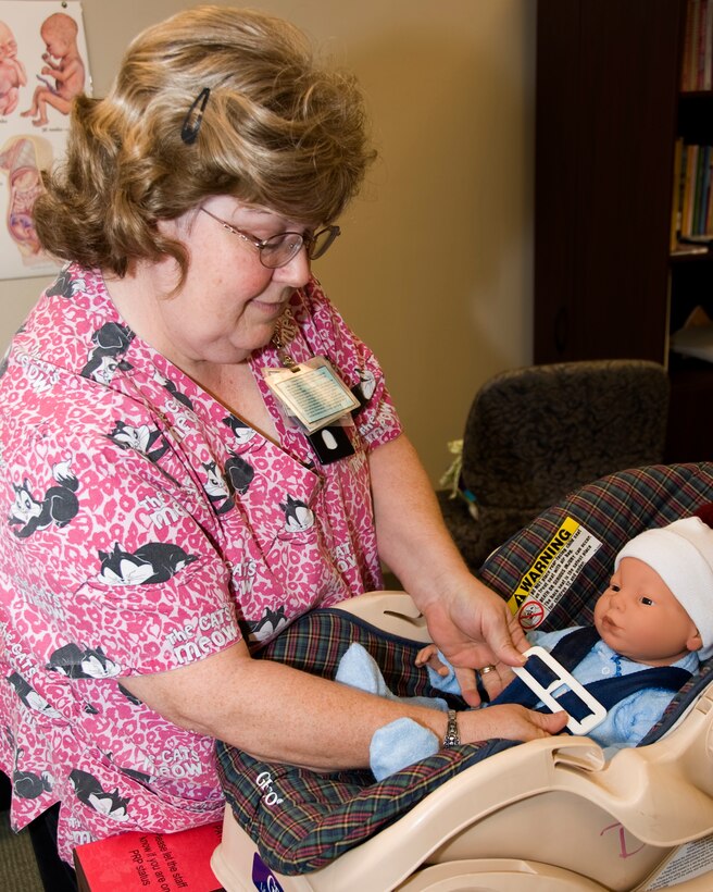 Barbara Kernott, 82nd Medical Operations Squadron Family Advocacy Child Passenger Safety Technician, demonstrates the proper tension and placement of a child safety seat straps. Six more applicants are being trained as child passenger safety technicians to assist in keeping children safe in vehicles through the use of proper restraints. (U.S. Air Force photo/Frank Carter)