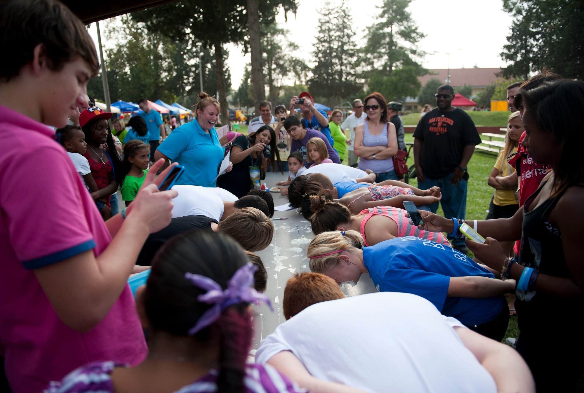 Members of Team Incirlik watch a pie eating contest during Fall Fest Oct. 20, 2012, at Incirlik Air Base, Turkey. The contest was one of many at Fall Fest, which is held annually by the 39th Force Support Squadron. (U.S. Air Force photo by Senior Airman Clayton Lenhardt/Released)