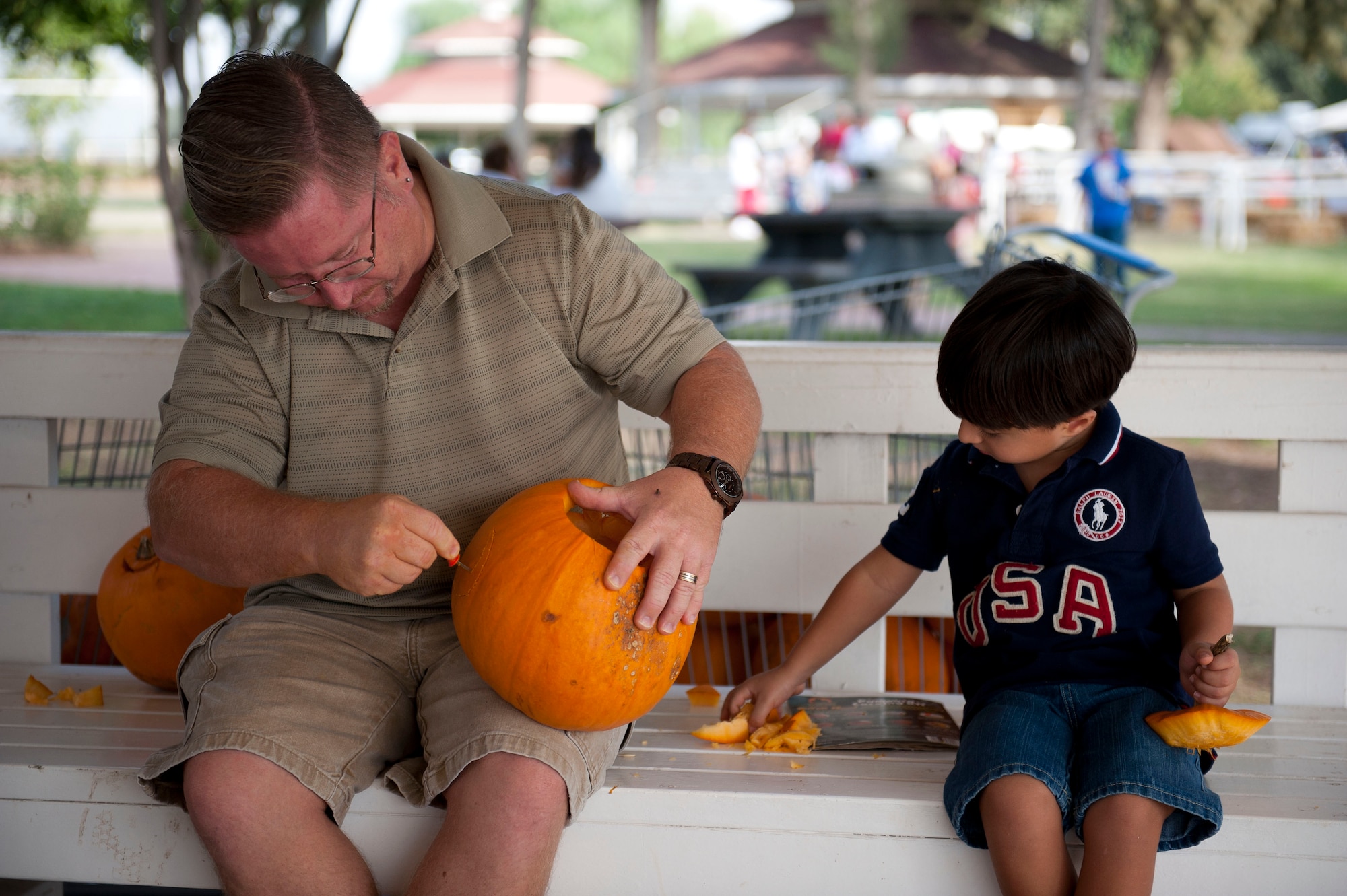 Steven Herb, Defense Logistics Agency, and his son carve a pumpkin for a contest during Fall Fest Oct. 20, 2012, at Incirlik Air Base, Turkey. Each contestant got to take their pumpkin home, and the winners of the contest received Army and Air Force Exchange Service gift cards. (U.S. Air Force photo by Senior Airman Clayton Lenhardt/Released)