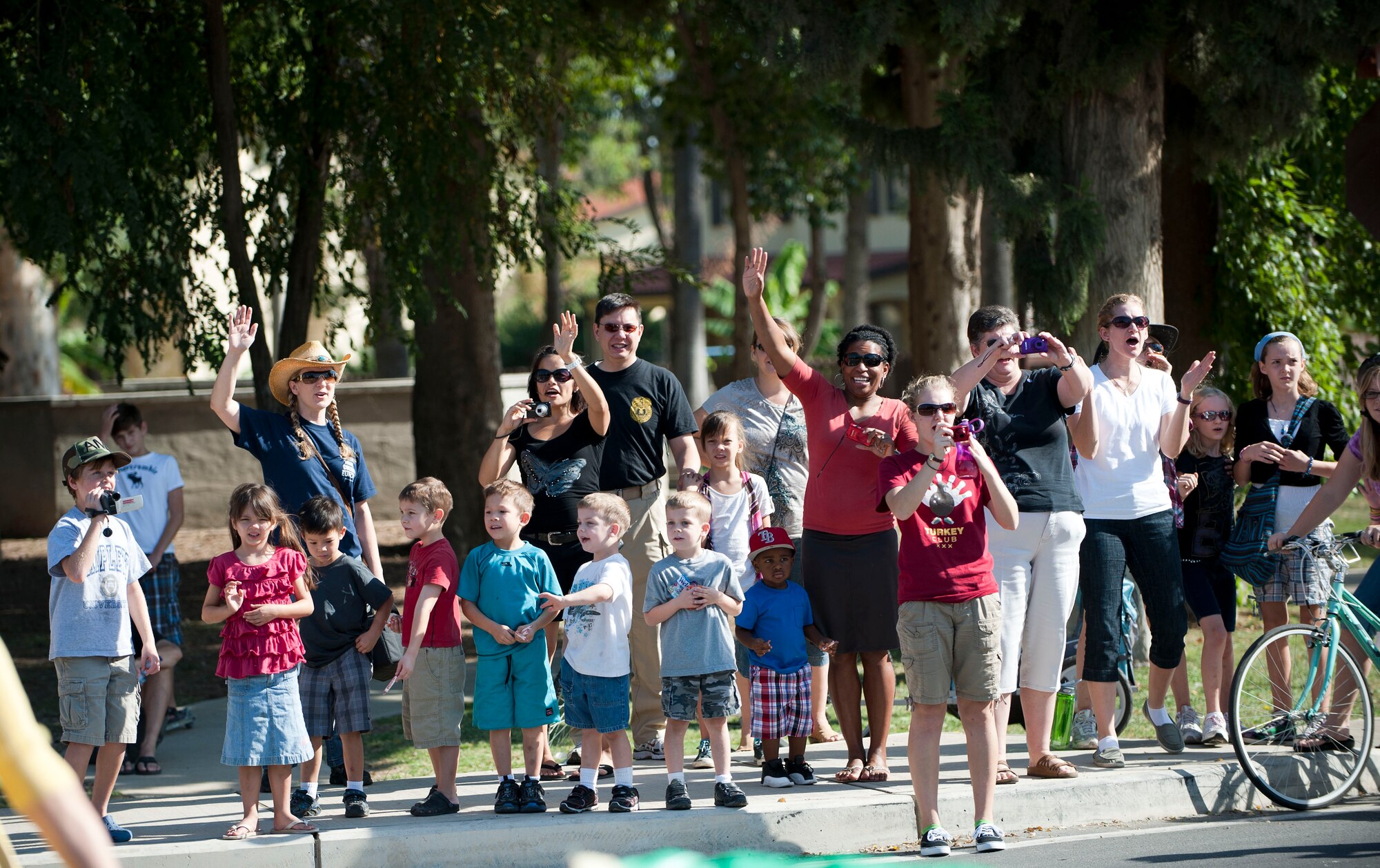 Members of Team Incirlik cheer during a parade to kick off Fall Fest Oct. 20, 2012, at Incirlik Air Base, Turkey. Each year, the 39th Force Support Squadron hosts Fall Fest to celebrate the new season while bringing a fair-like atmosphere to Incirlik. (U.S. Air Force photo by Senior Airman Clayton Lenhardt/Released)