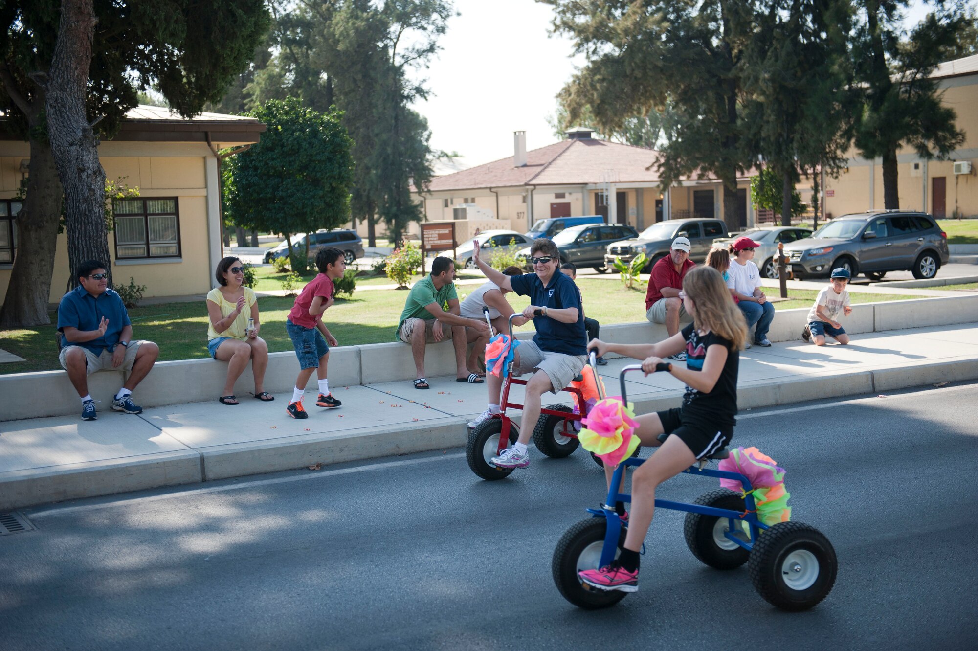Chief Master Sgt. Nancy Judge, 39th Air Base Wing command chief, waves to members of Team Incirlik during a parade to kick off Fall Fest Oct. 20, 2012, at Incirlik Air Base, Turkey. The parade route led to Arkadas Park where there were food booths, carnival games, camel and pony rides to celebrate autumn at Incirlik. (U.S. Air Force photo by Senior Airman Clayton Lenhardt/Released)