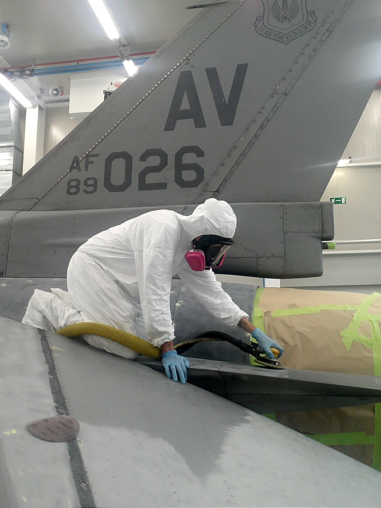 Staff Sgt. Jeffrey Russell, 31st Maintenance Squadron aircraft structural maintenance corrosion control, sands a fast-acting speed brake prior to repainting an F-16 Fighting Falcon.The 31st MXS unveiled Aviano's first locally-painted F-16 during a ribbon cutting of the new Corrosion Control Facility Oct. 19 located on Aviano Air Base, Italy. (Courtesy Photo)