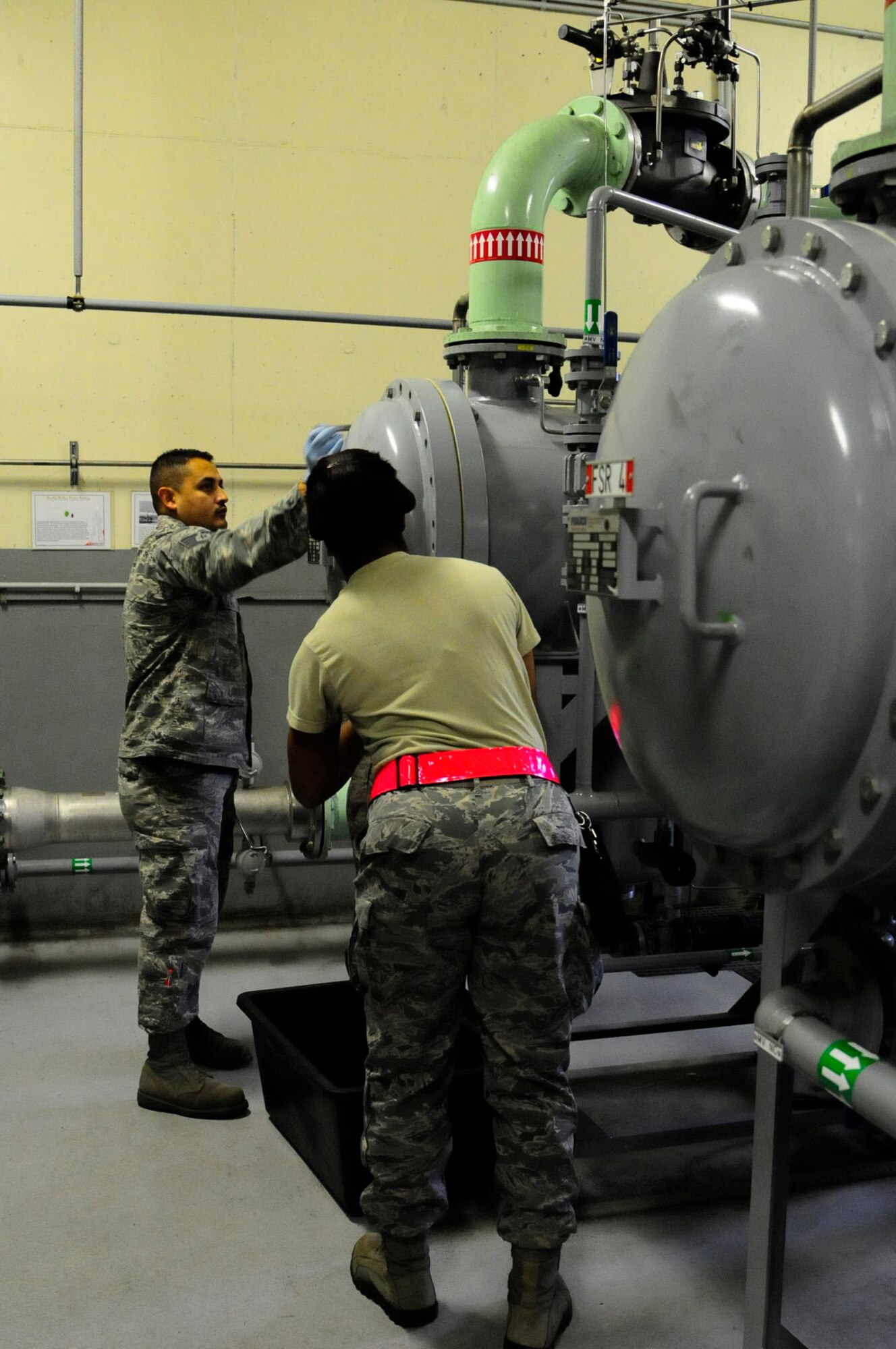 Staff Sgt. Luis Lepe, 786th Civil Engineer Squadron liquid fuels craftsman (left), and Staff Sgt. Tamara Stovall, 786th CES water and fuels systems maintenance craftsman (right), change fuel filters on Ramstein Air Base, Germany, Oct. 17, 2012. Changing filters often helps ensure fuel gets cleaned properly. (U.S. Air Force photo/Airman 1st Class Hailey Haux)