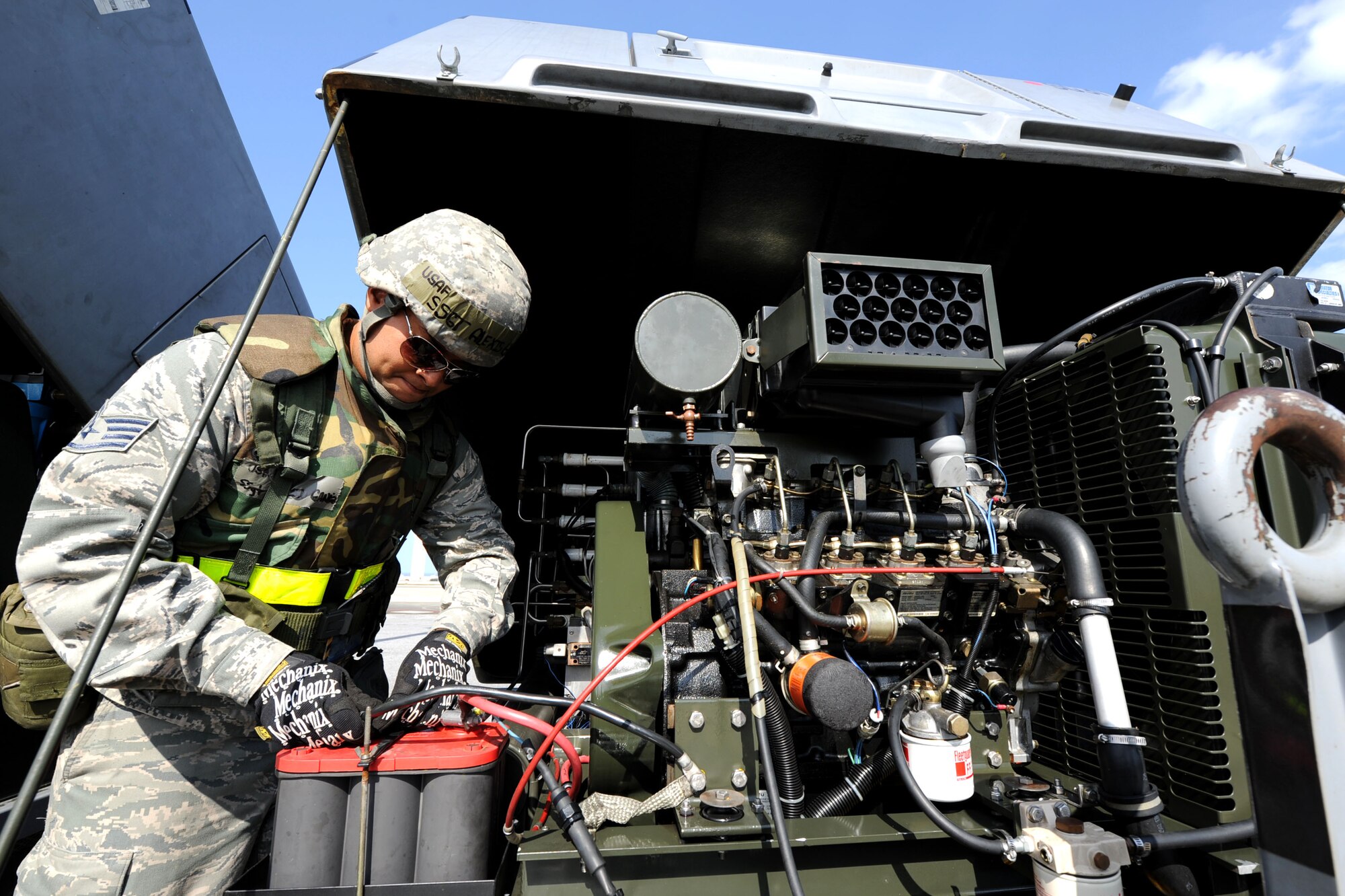 U.S. Air Force Staff Sgt. Alexis Gandia-Salgado, 18th Equipment Maintenance Squadron Aircraft Ground Equipment craftsman, performs routine maintenance on a generating nitrogen carts during a Pacific Air Forces readiness inspection on Kadena Air Base, Okinawa, Oct. 24, 2012. Although there is an inspection, real-world operations must continue while simulation injects test the base’s ability to survive and operate during contingencies. (U.S. Air Force photo/Airman 1st Class Brooke P. Beers)