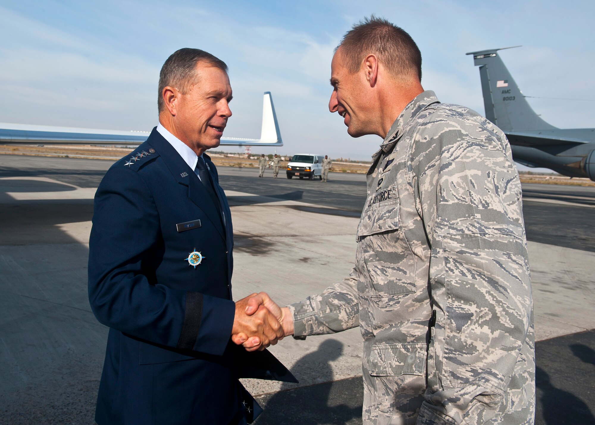 Gen. William M. Fraser III (left), U.S. Transportation Command commander, is greeted by Col. Corey Martin, 376th Air Expeditionary Wing commander, at the Transit Center at Manas, Kyrgyzstan, Oct. 22, 2012. Fraser visited with deployed service members and learned about the day-to-day operations conducted at the Transit Center. (U.S. Air Force photo/Senior Airman Brett Clashman)