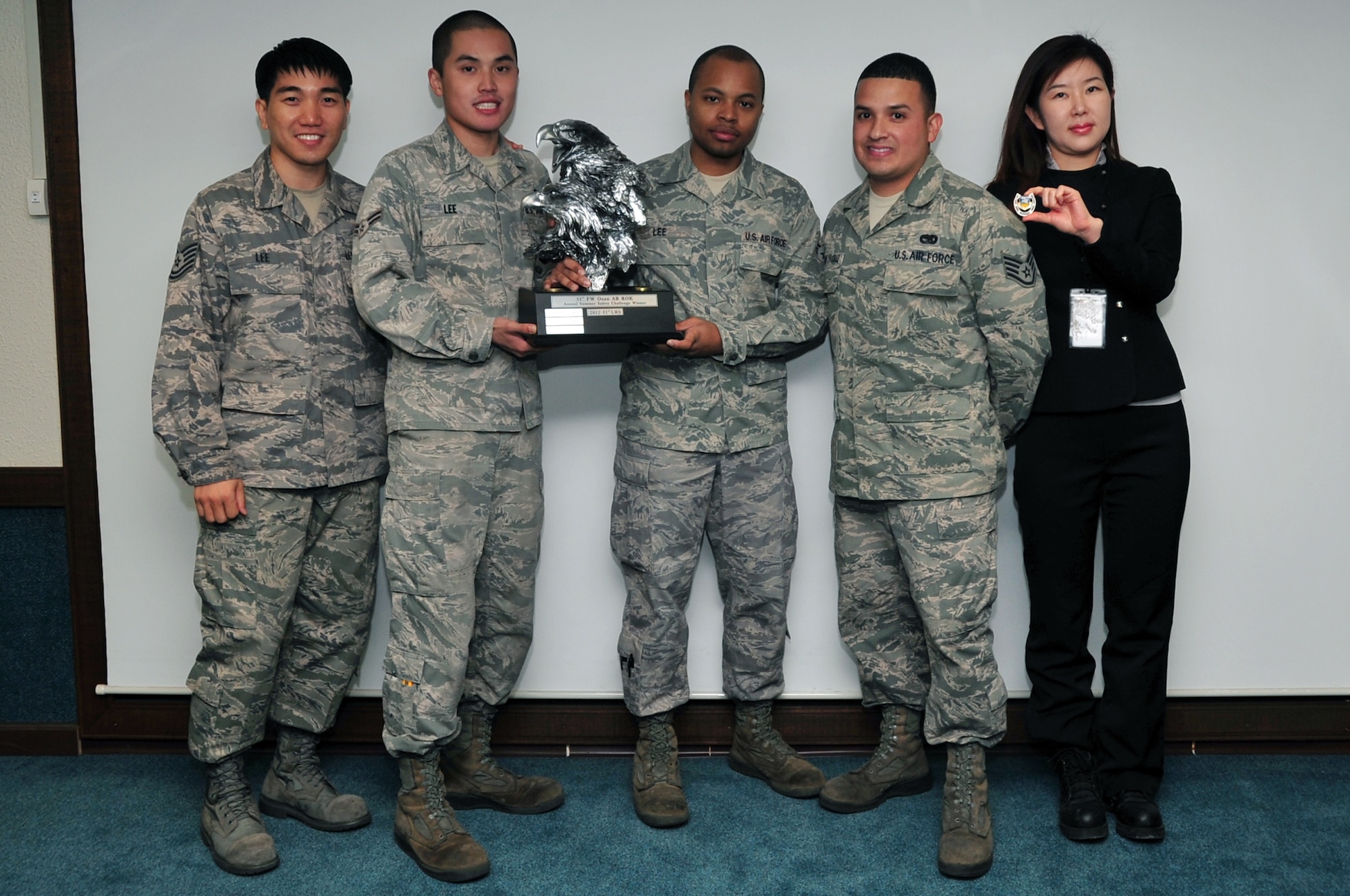 Members of the 51st Logistics Readiness Squadron pose with the 2012 Summer Safety Challenge traveling trophy Oct. 19, 2012. In an effort to increase awareness about staying safe during the Air Force’s Critical Days of Summer campaign, the 51st Fighter Wing Safety office challenged the base to a competition to get involved and find ways to reduce mishaps. The 51st LRS conducted more than 6,000 seatbelt checks, 300 bicycle checks and an 80-person FOD walk that garnered them the winning spot. (From left to right) Tech. Sgt. Chul Lee, Airman 1st Class Nigel Lee, Senior Airman Kevin Lee, Staff Sgt. Juan Torres Dela Cruz, and Hyon-Mi Chon. (U.S. Air Force photo/Staff Sgt. Craig Cisek)