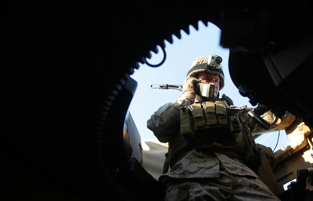 Marine Corps Capt. James Slocum calls in an improvised explosive device during a mounted convoy patrol on Marine Corps Auxiliary Landing Field Bogue, N.C., Oct. 18, 2012.  Slocum, a turret gunner, will deploy to Afghanistan as member of a security force assistance adviser team.