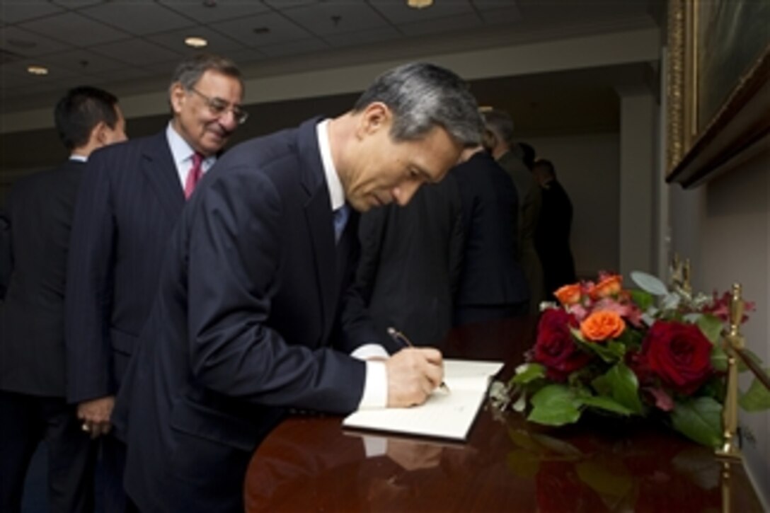 Secretary of Defense Leon E. Panetta, left, watches as South Korea's Minister of National Defense Kim Kwan-jin signs the guest book in the Pentagon on Oct. 24, 2012.  Panetta and Kim, along with their senior advisors and foreign affairs officials, will meet for the 44th U.S.-Republic of Korea Security Consultative Meeting.  