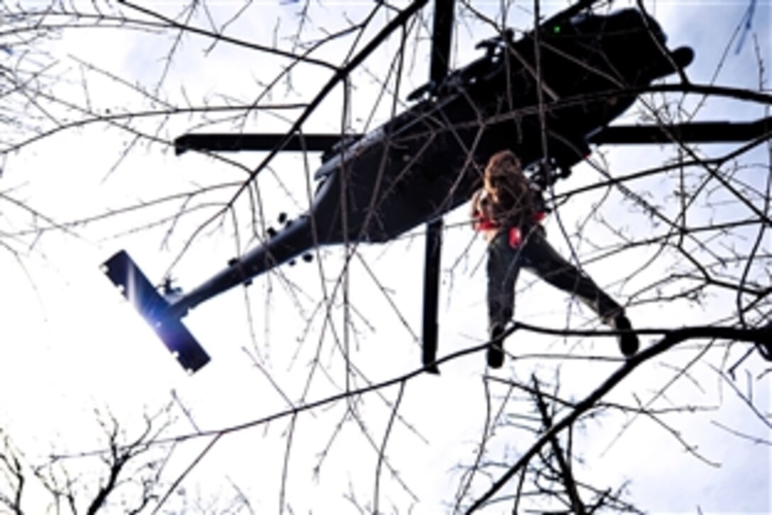 U.S. Air Force Staff Sgt. Dane Hatley is hoisted into an HH-60 Pave Hawk helicopter as part of a combat search and rescue scenario during exercise Pacific Thunder 2012 near Osan Air Base, South Korea, Oct. 15, 2012. Hatley, a flight engineer, is assigned to the 33rd Rescue Squadron. 